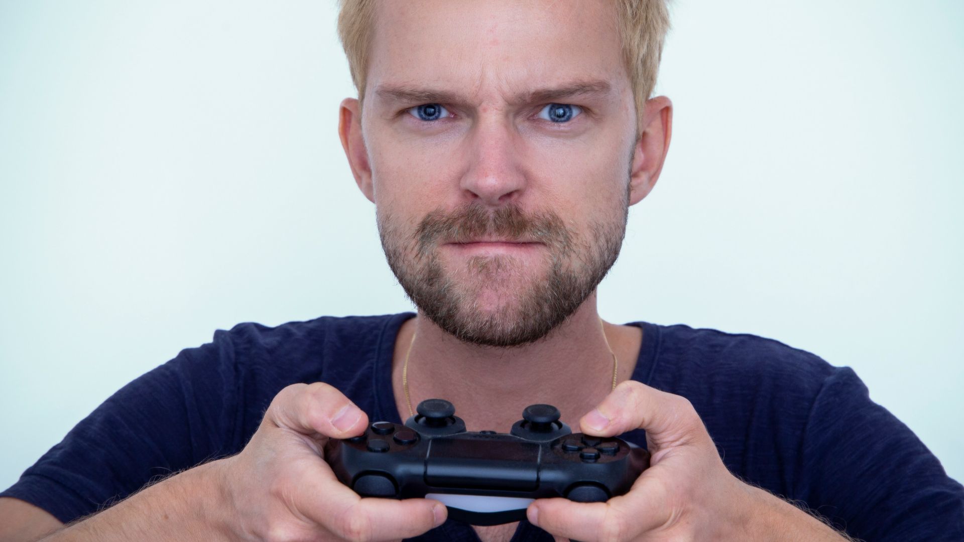man in blue long sleeve shirt holding black semi automatic pistol