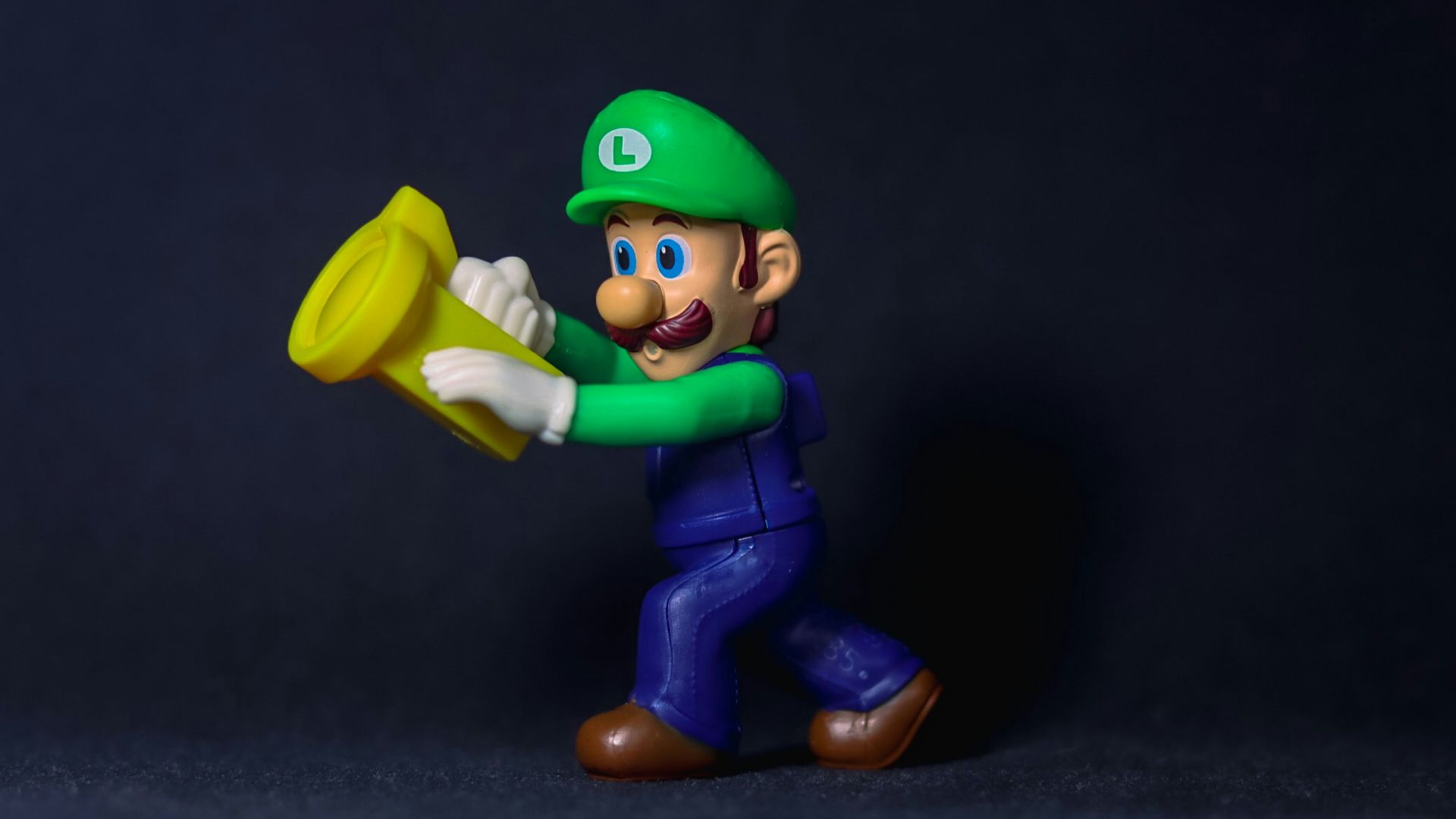 a figurine of a man holding a yellow frisbee