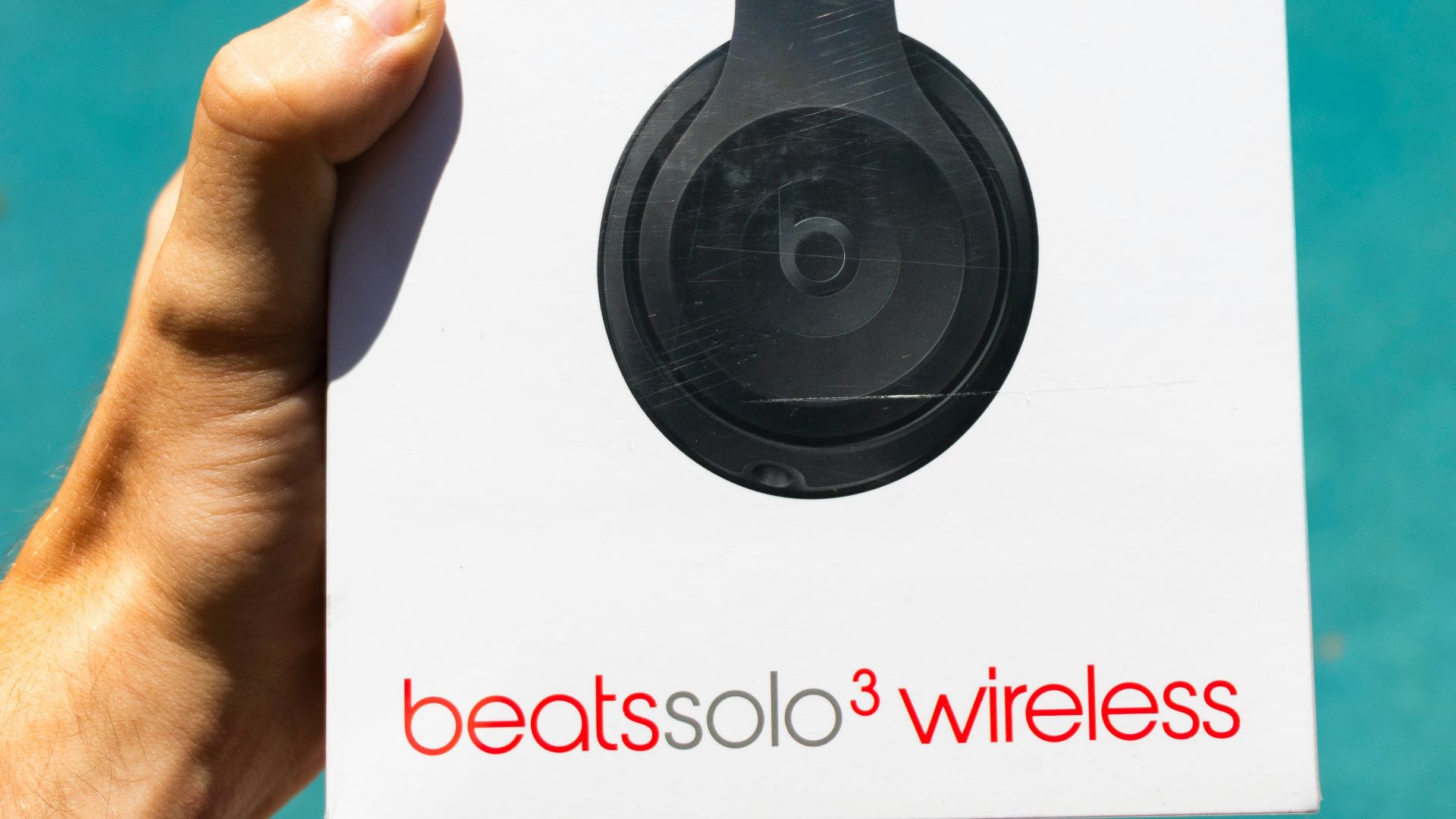 person holding Beats by Dr. Dre Beatssolo3 wireless box