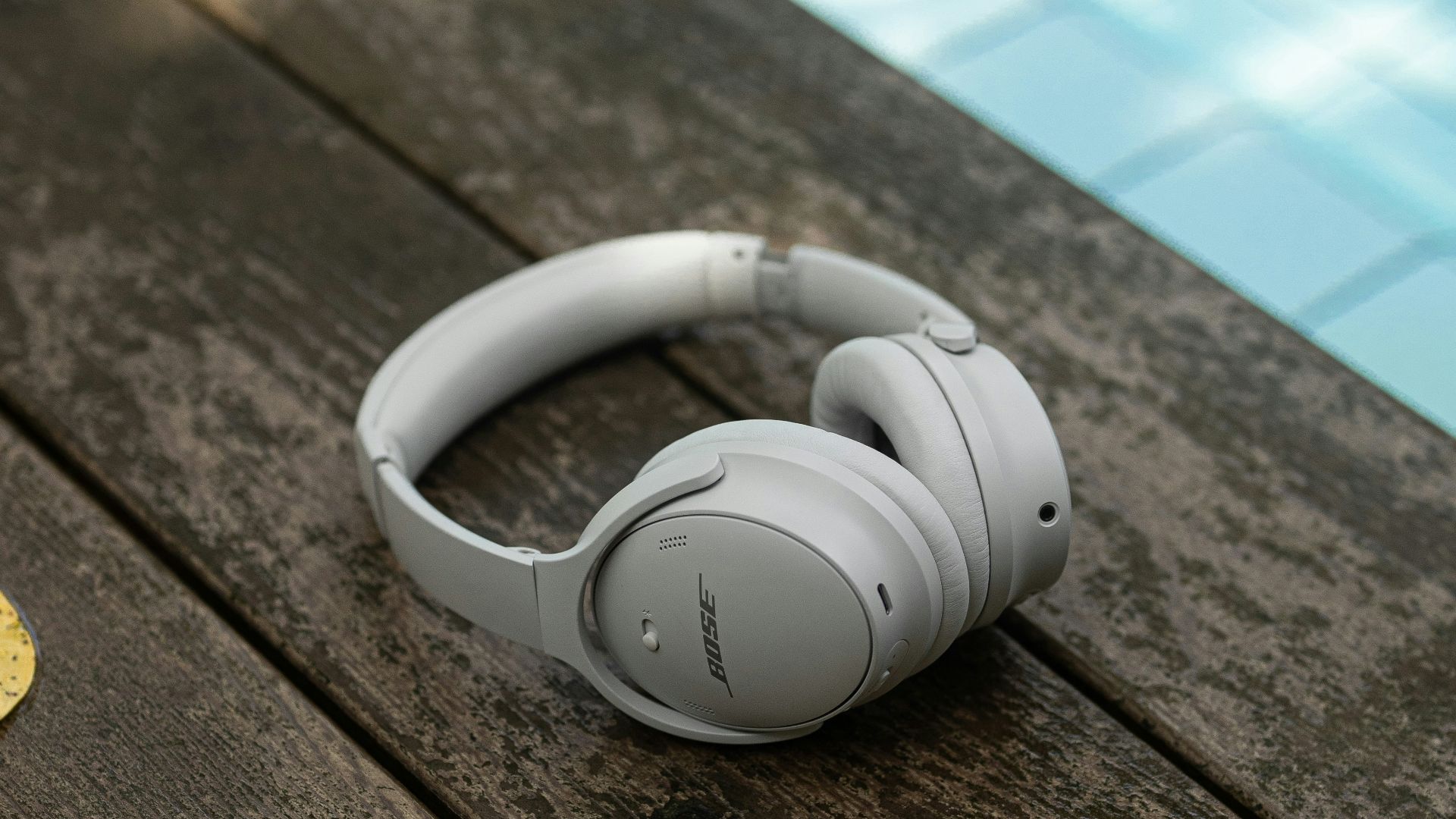 a pair of headphones sitting on top of a wooden table