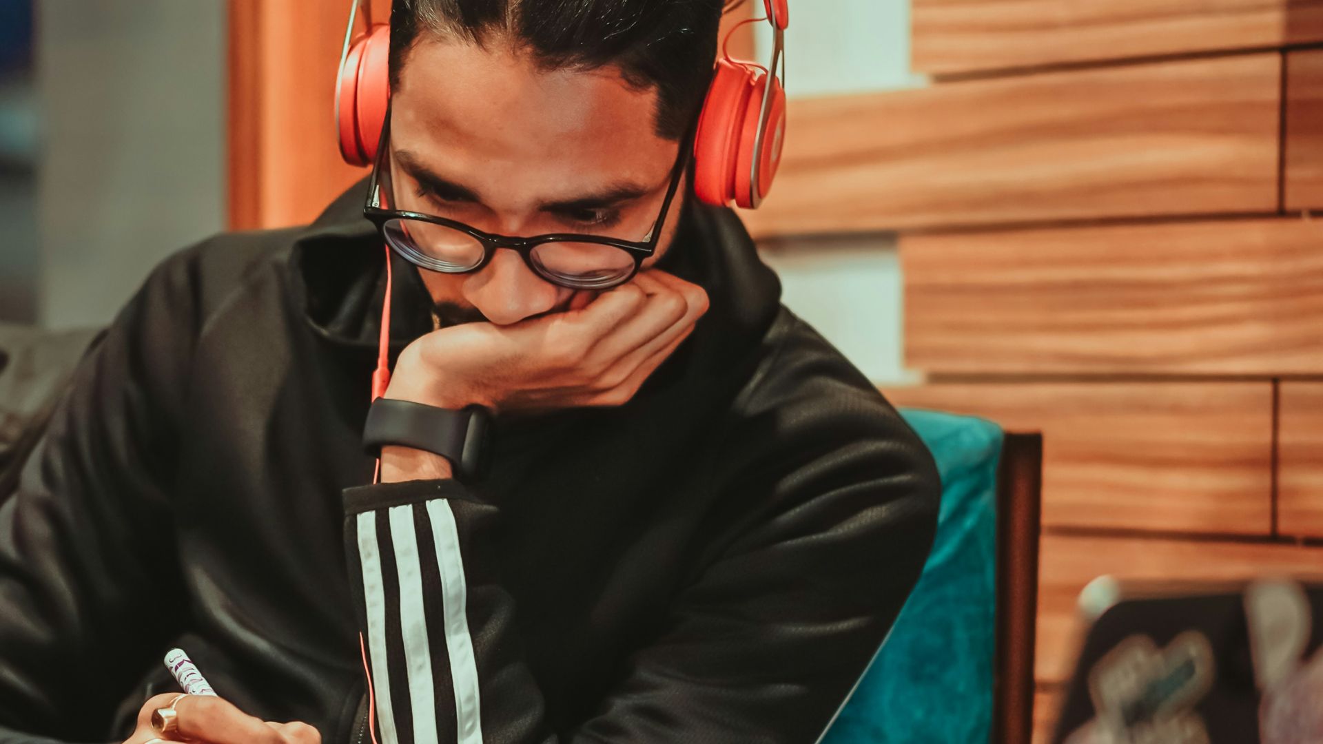 man in black jacket sitting on chair