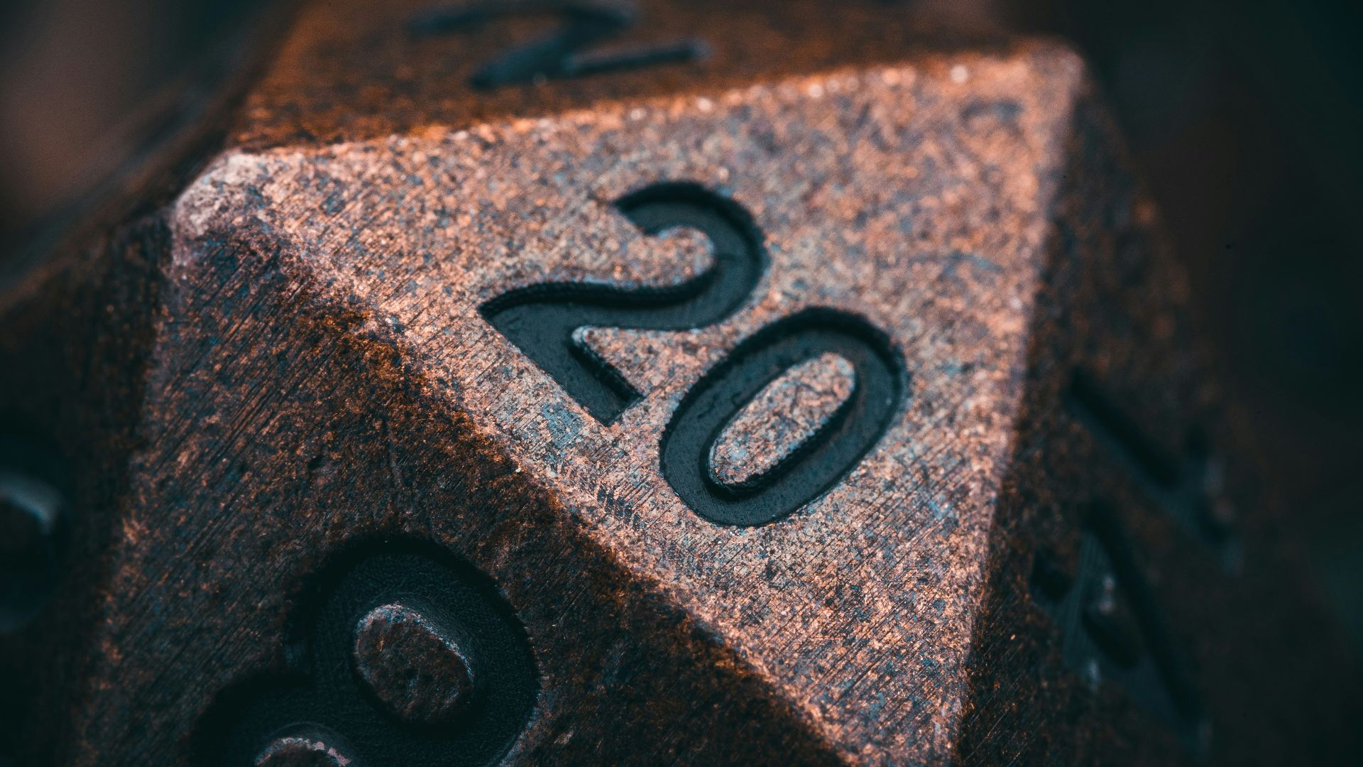 a metal dice with the number twenty on it