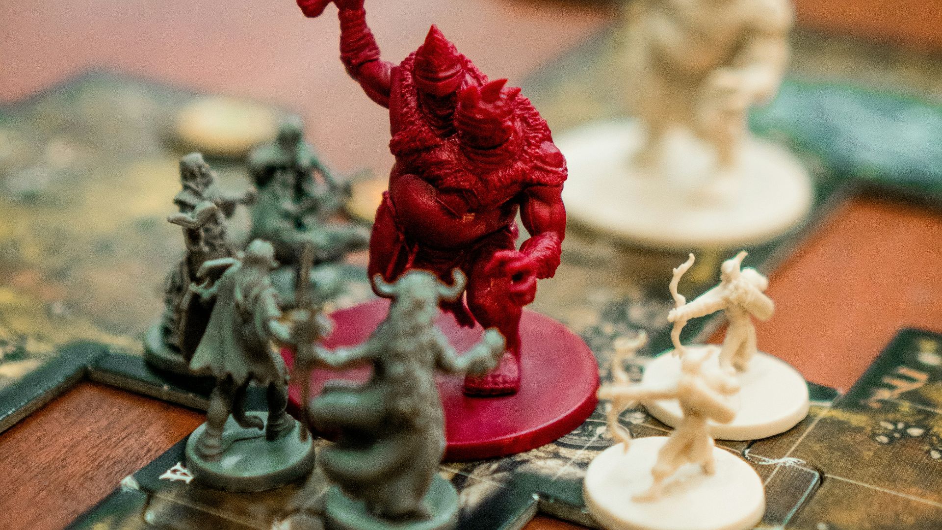 red, white, and green action figures on table