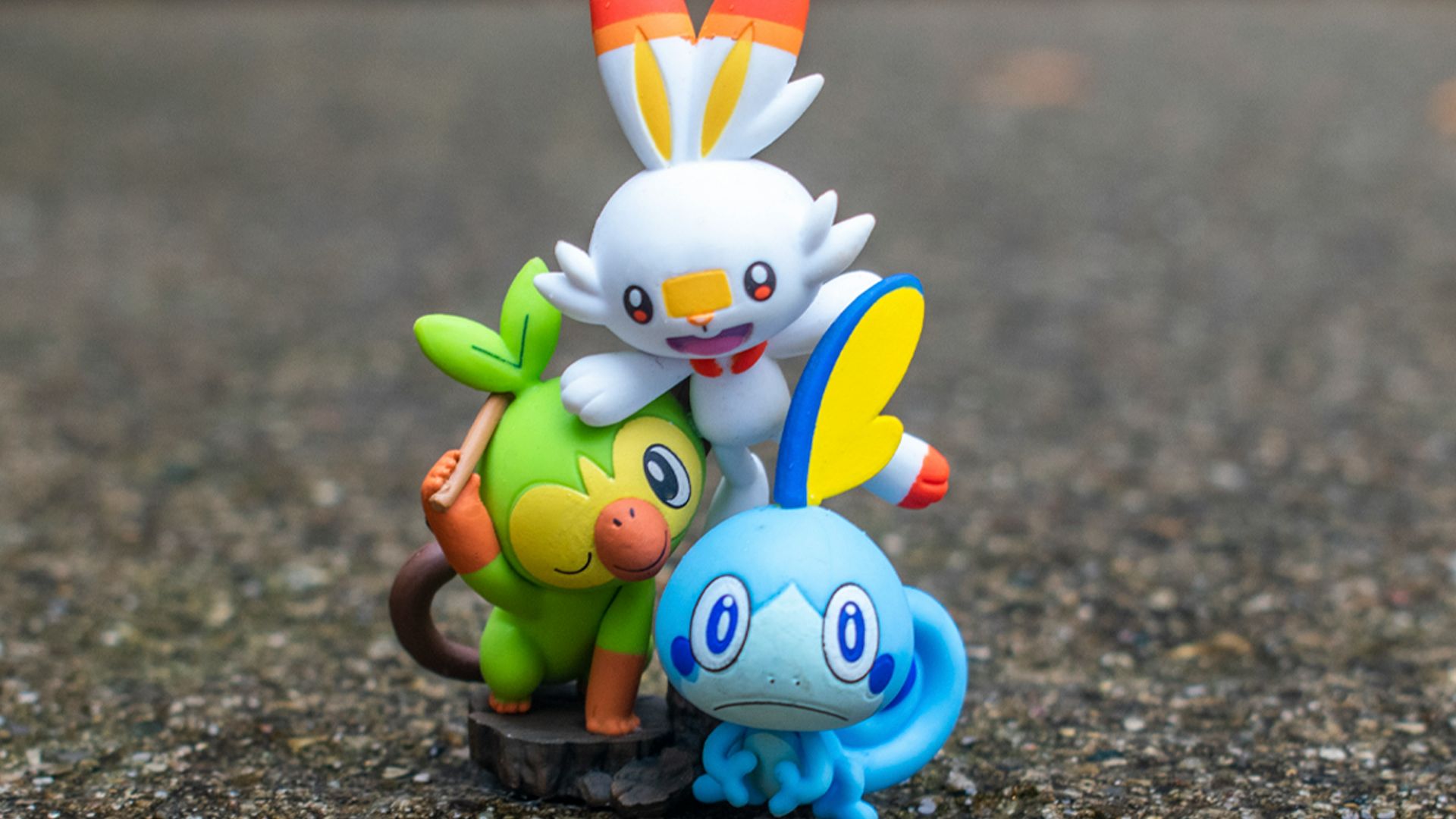 a group of pokemon figurines sitting on top of a rock