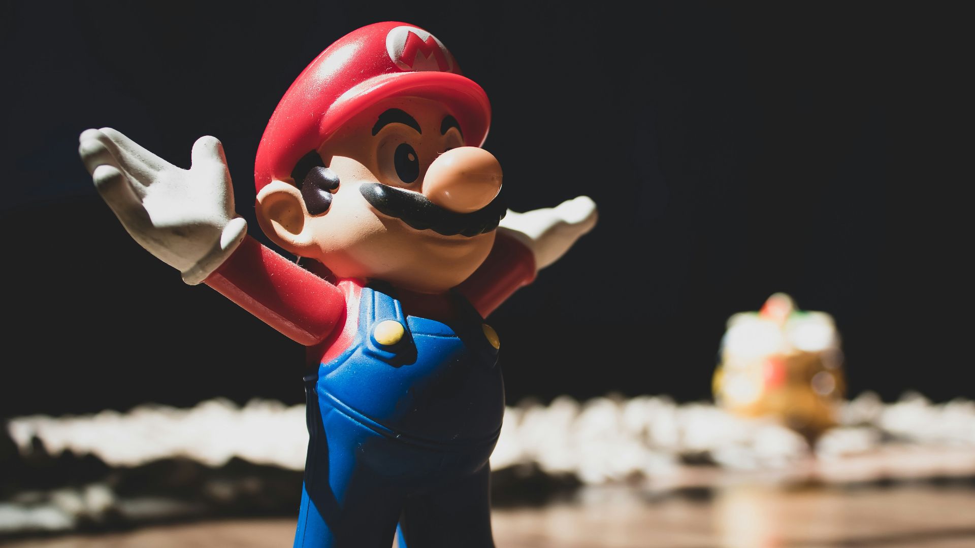 Super Mario figurine on brown surface
