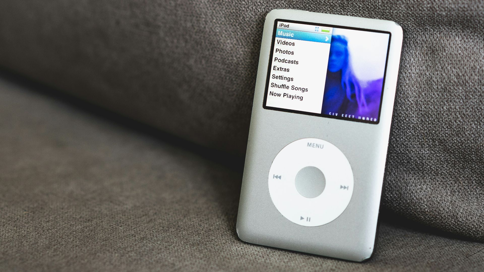 an ipod sitting on top of a couch