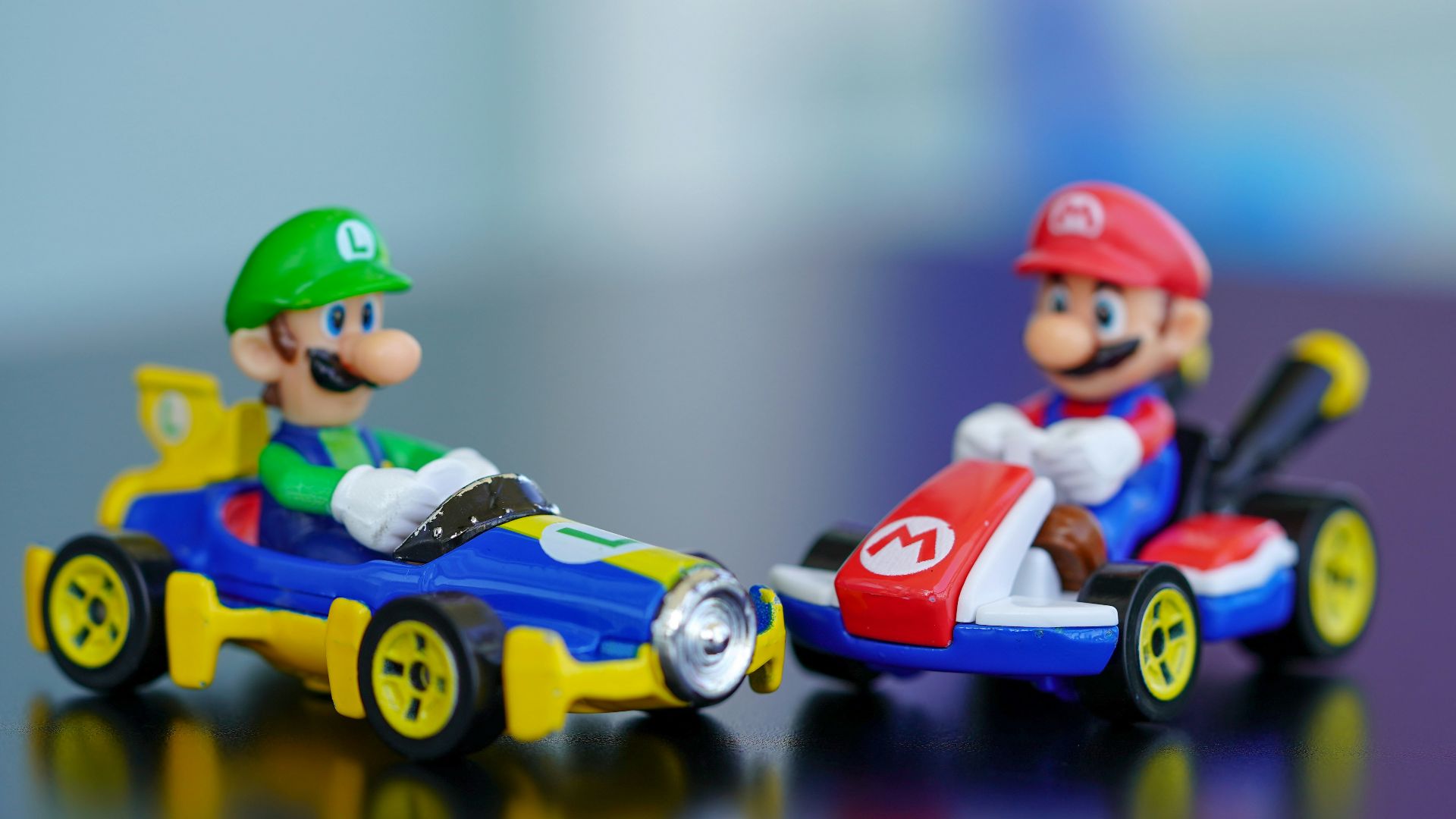 man in red helmet riding orange and blue f 1 car toy