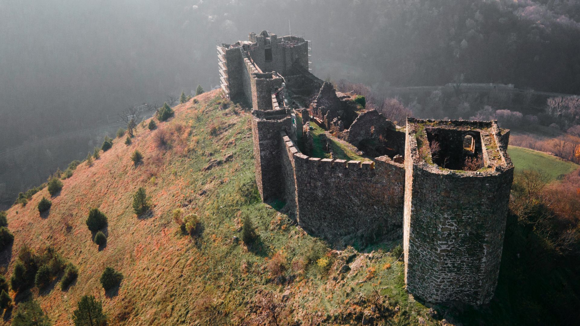 an aerial view of a castle on top of a hill