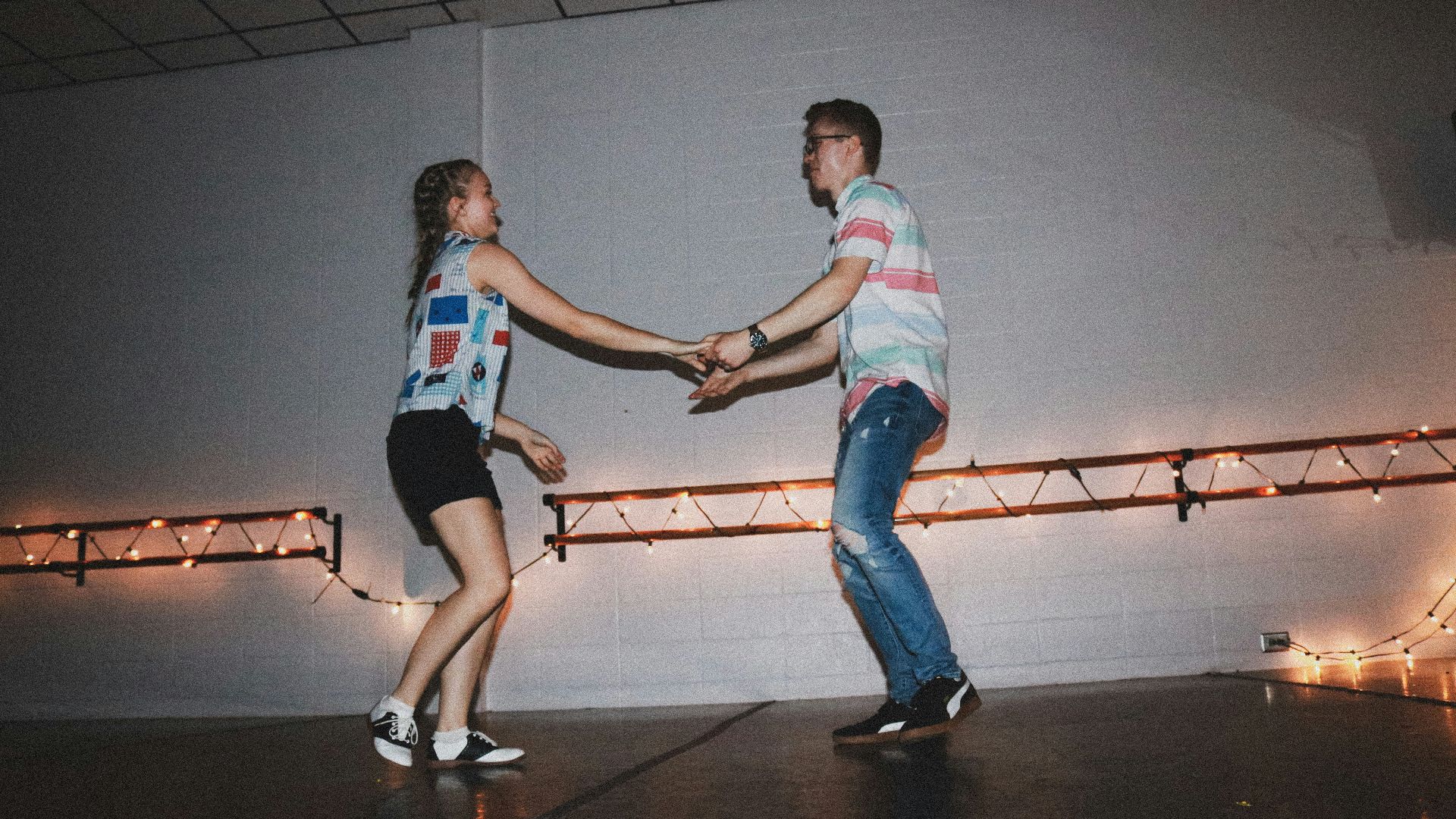 woman and man standing near wall