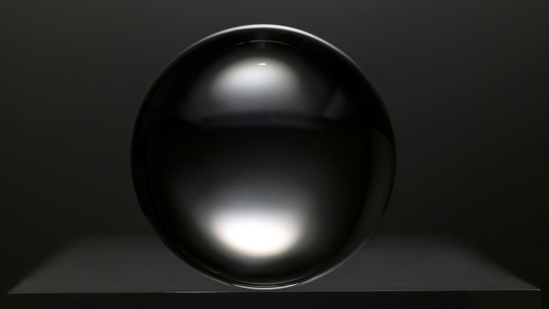 black round ball on white surface
