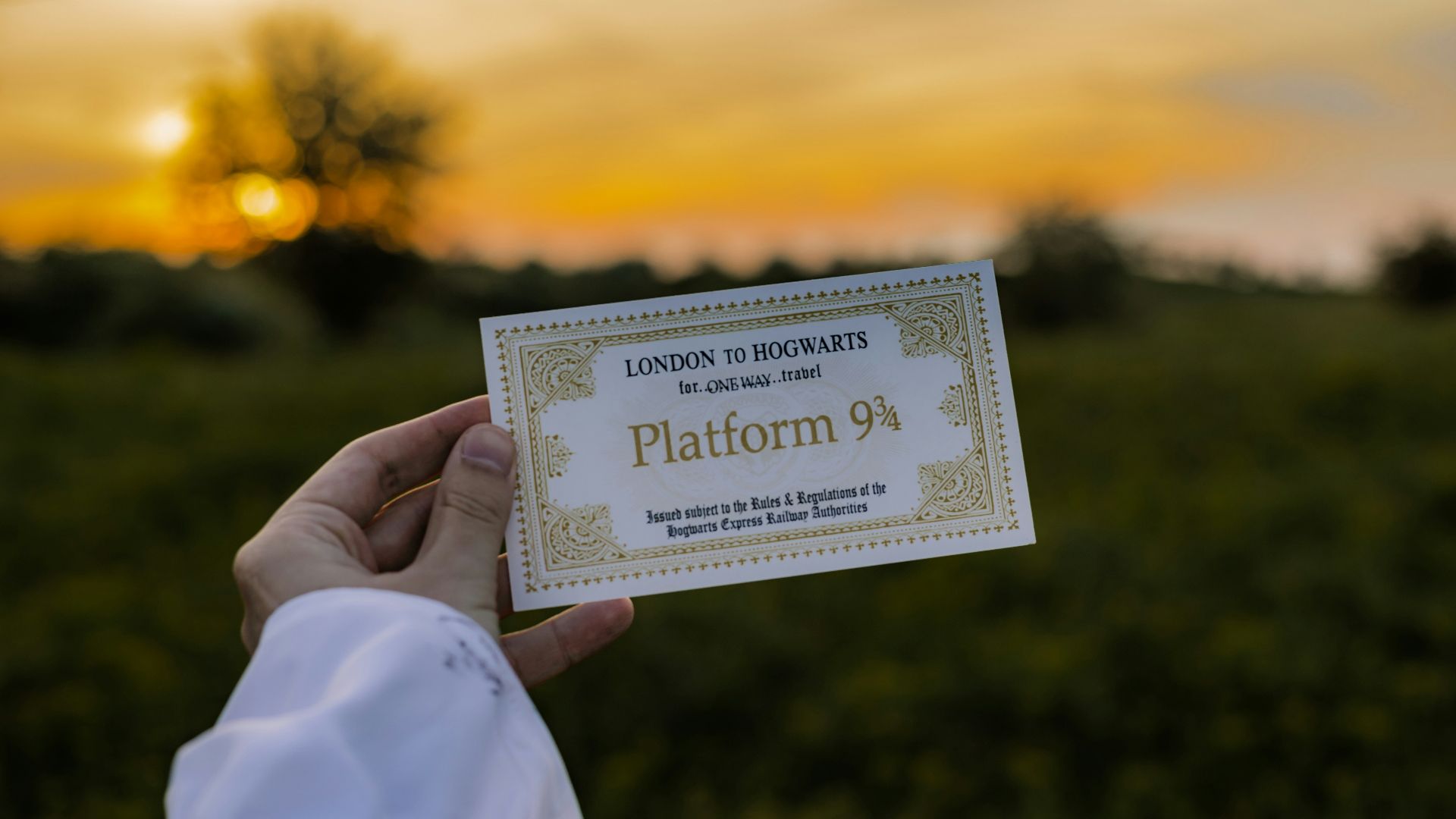 a person holding up a business card in a field
