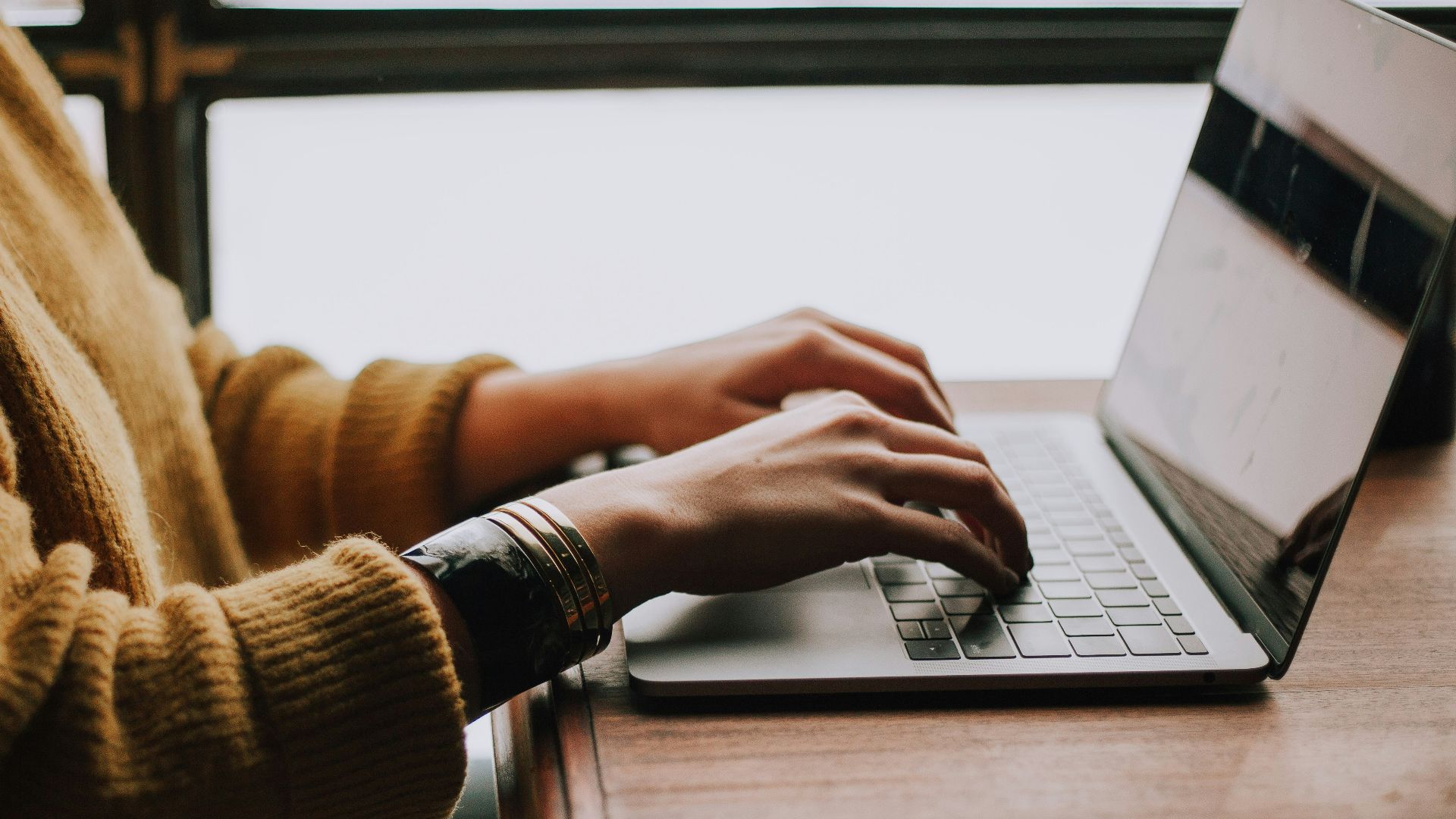 person sitting front of laptop