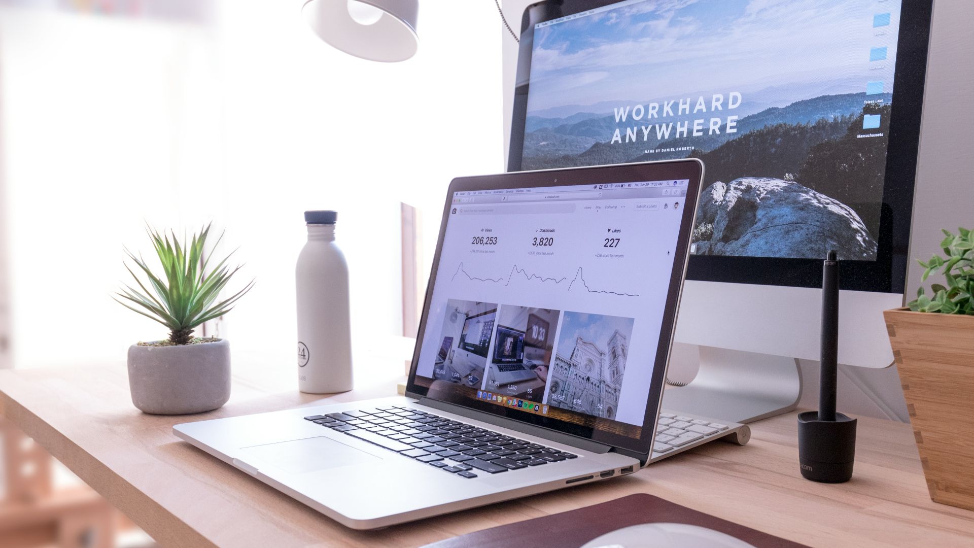 MacBook Pro on table beside white iMac and Magic Mouse