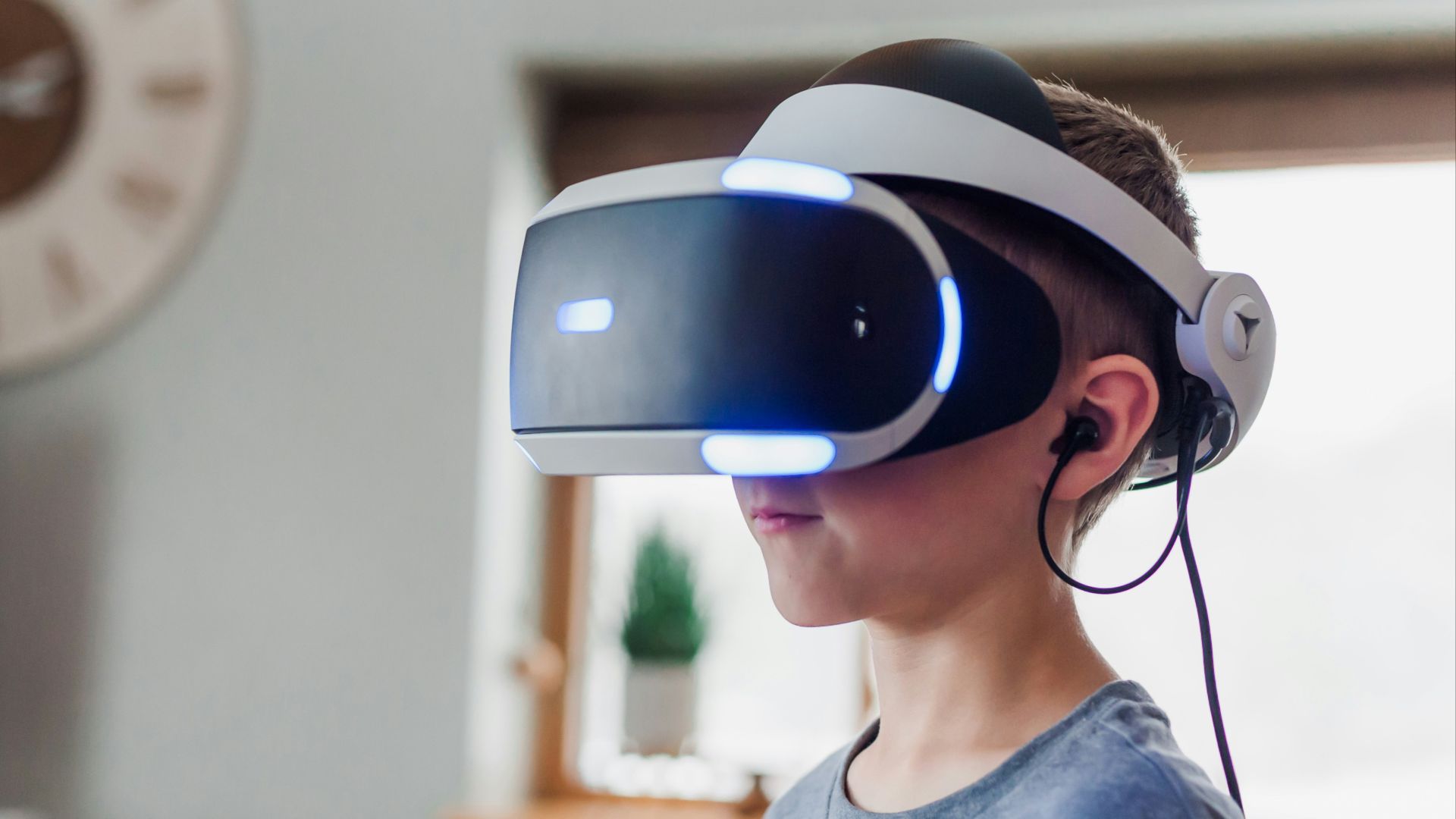 boy wearing black and white VR headset
