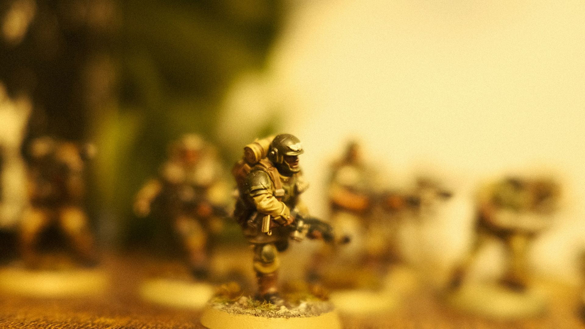 Miniature soldiers are displayed with a blurry background.