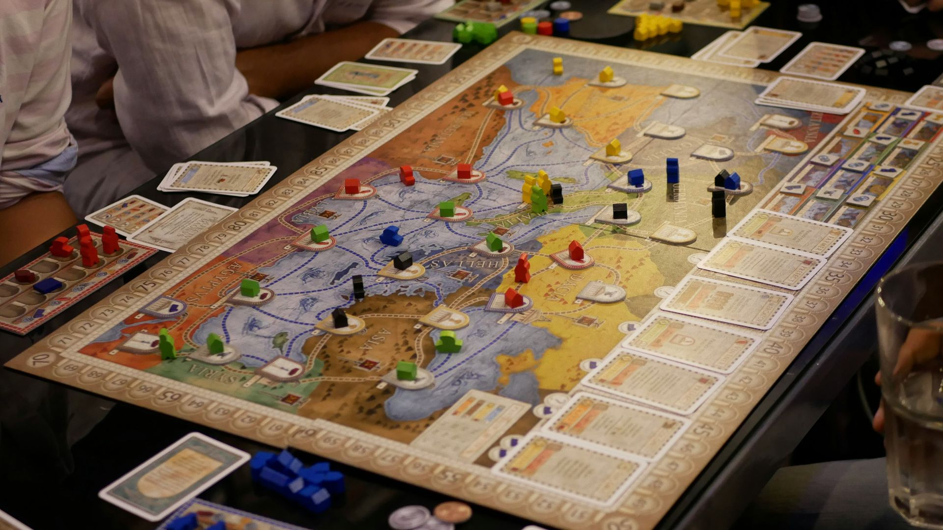 person in white shirt sitting beside table with puzzle game