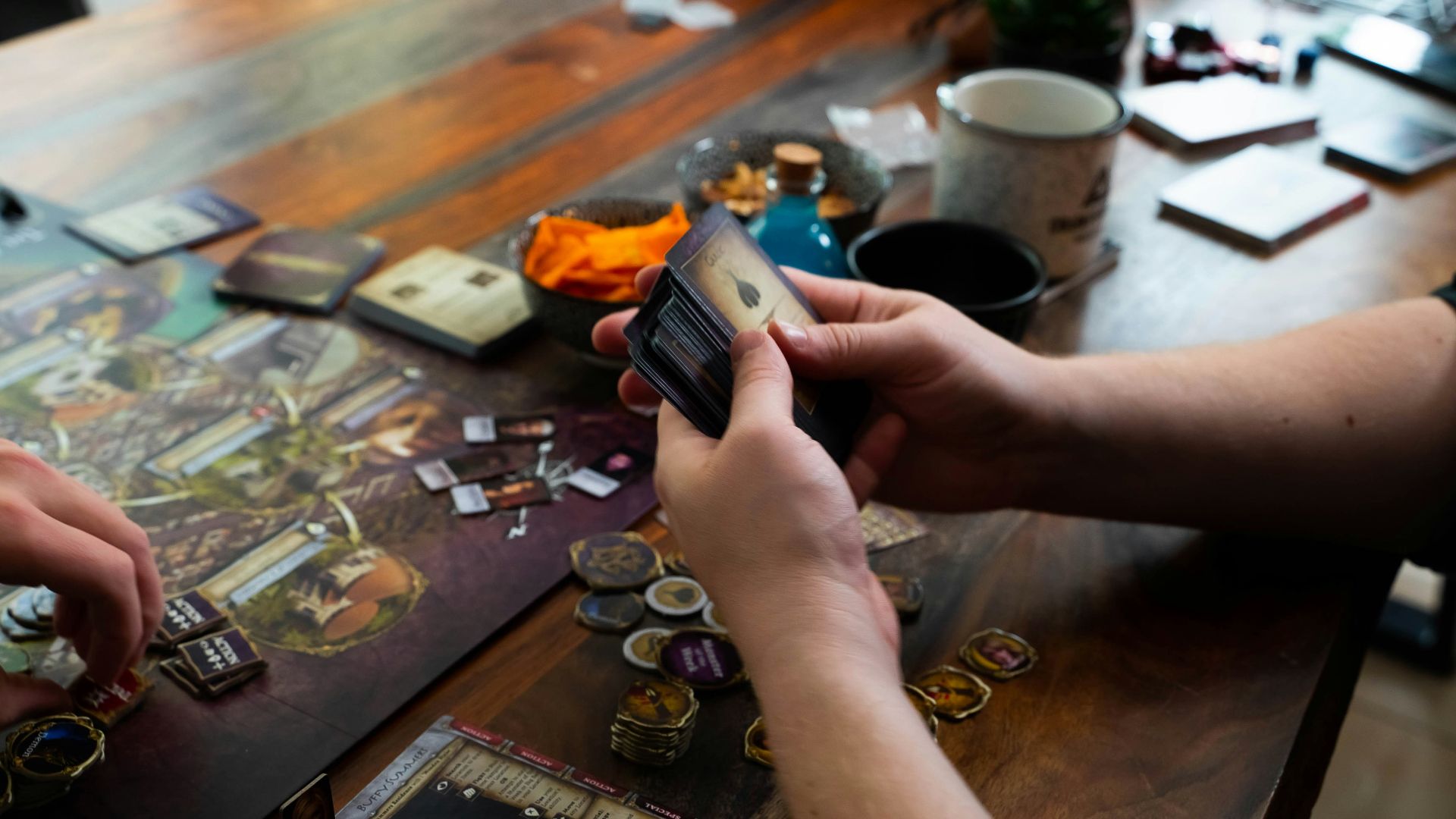 two people playing a board game on a table