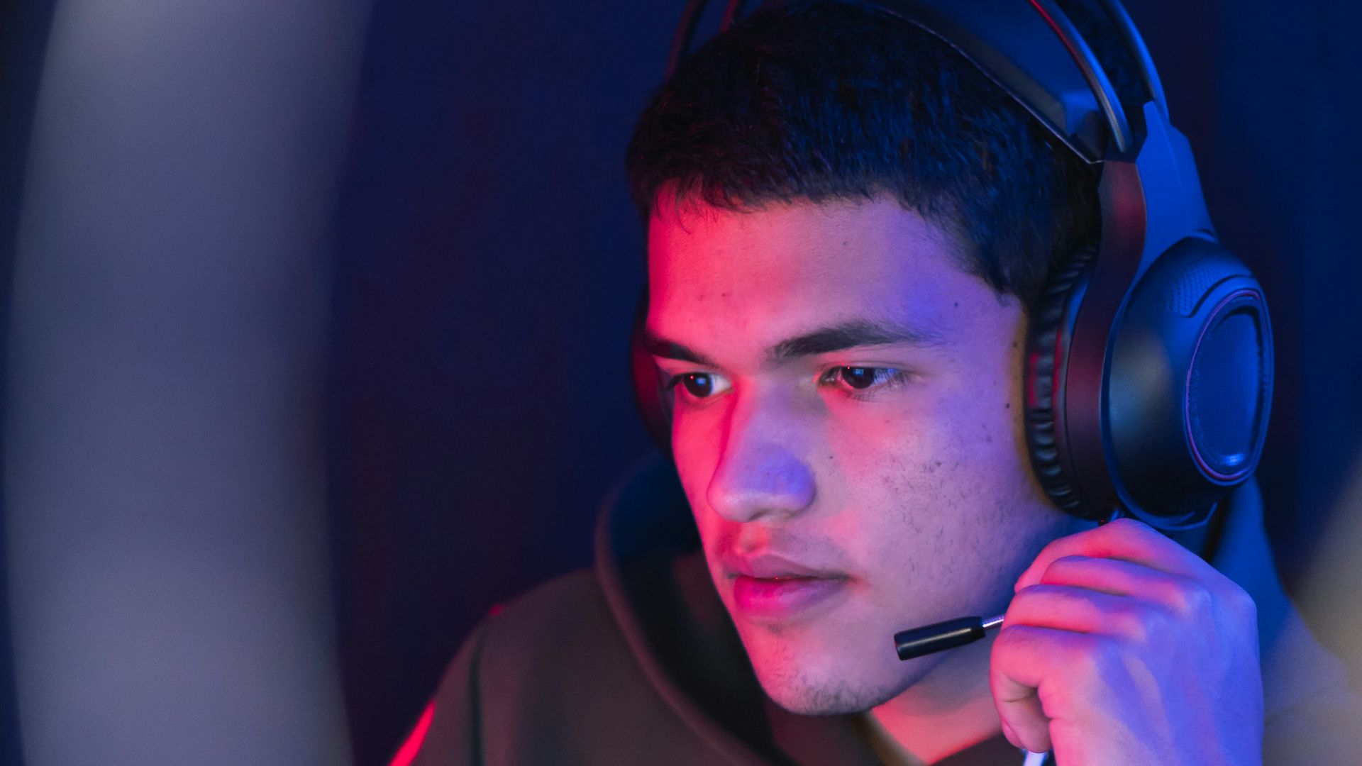 man in red hoodie wearing black headphones