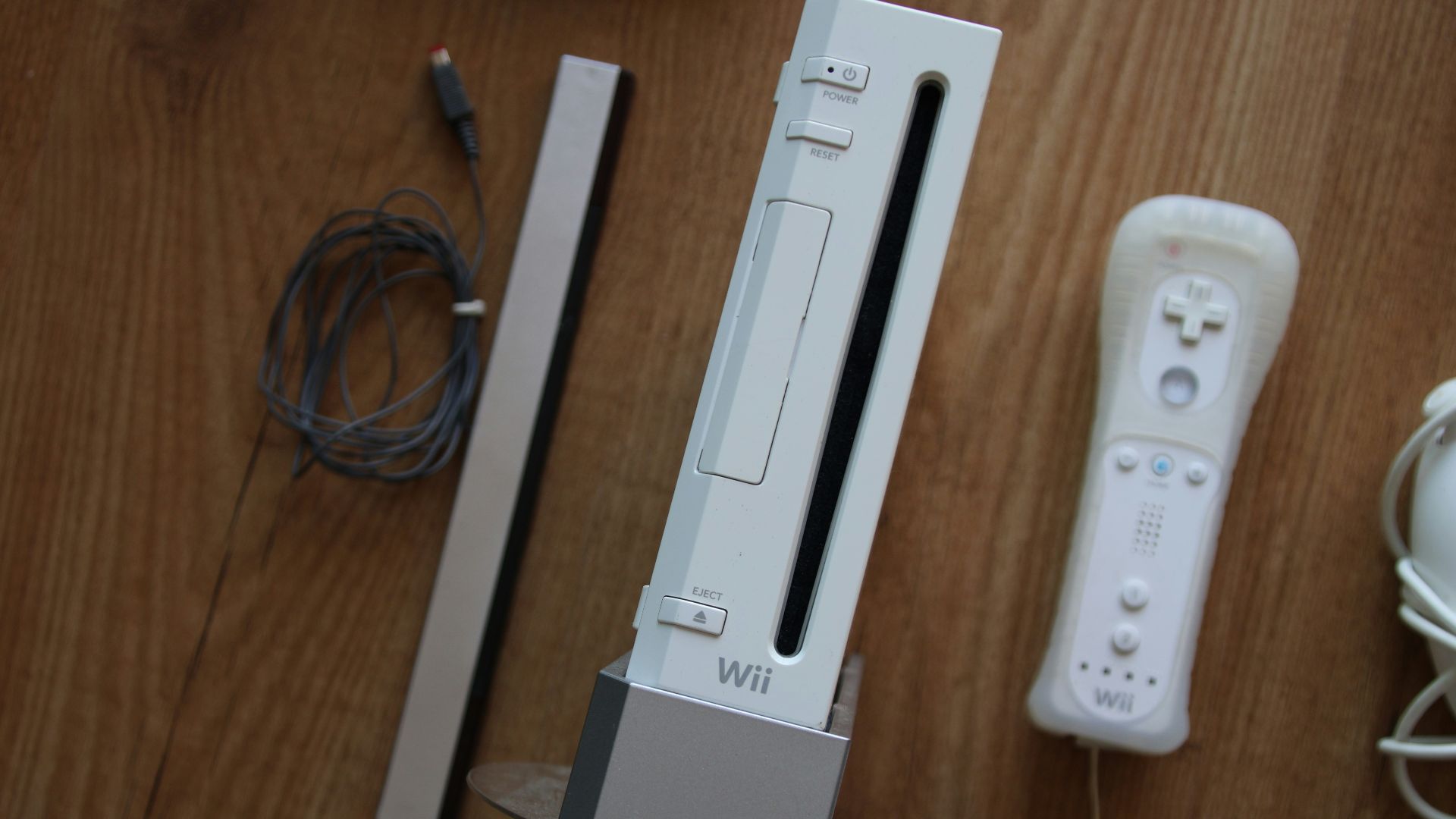 a nintendo wii game system sitting on top of a wooden table