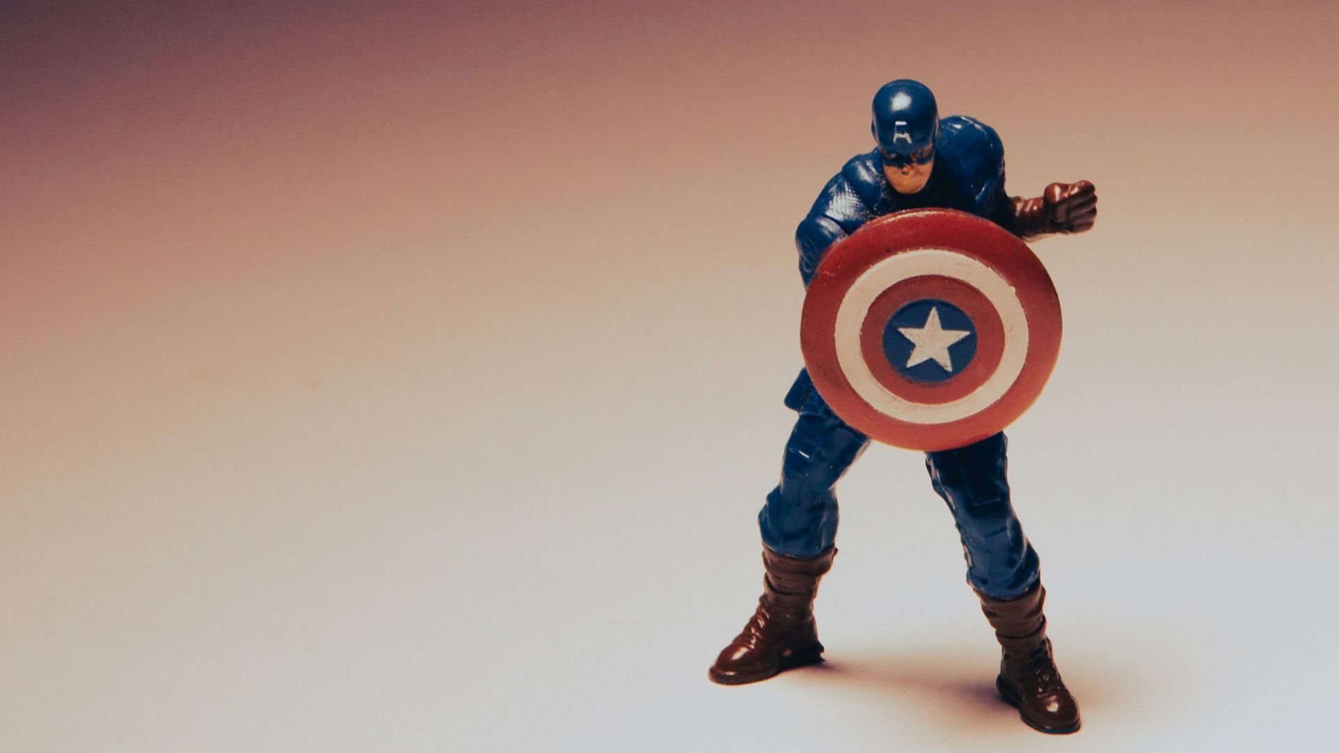 a toy of a captain america holding a shield