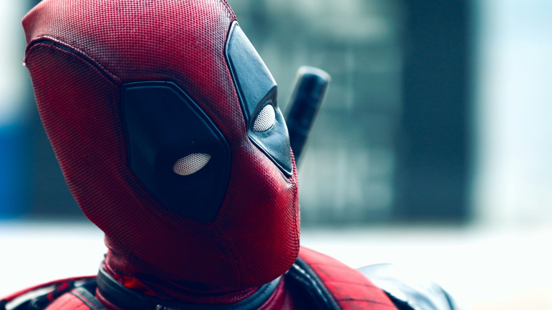 a man in a deadpool costume with a knife in his hand