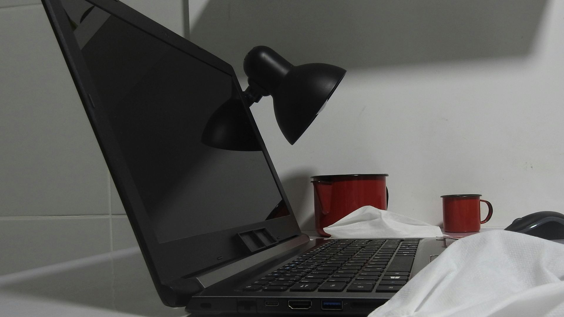 a laptop computer sitting on top of a white counter