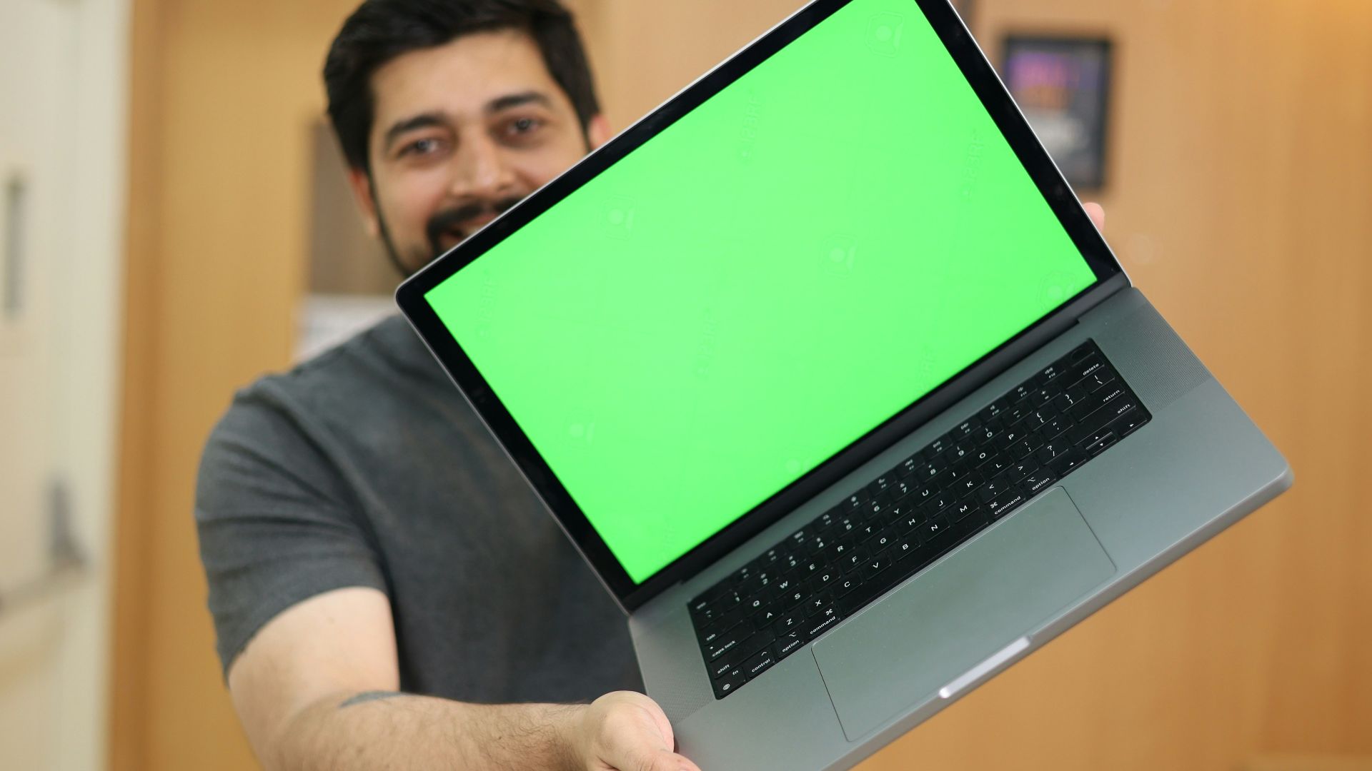 a man holding a laptop