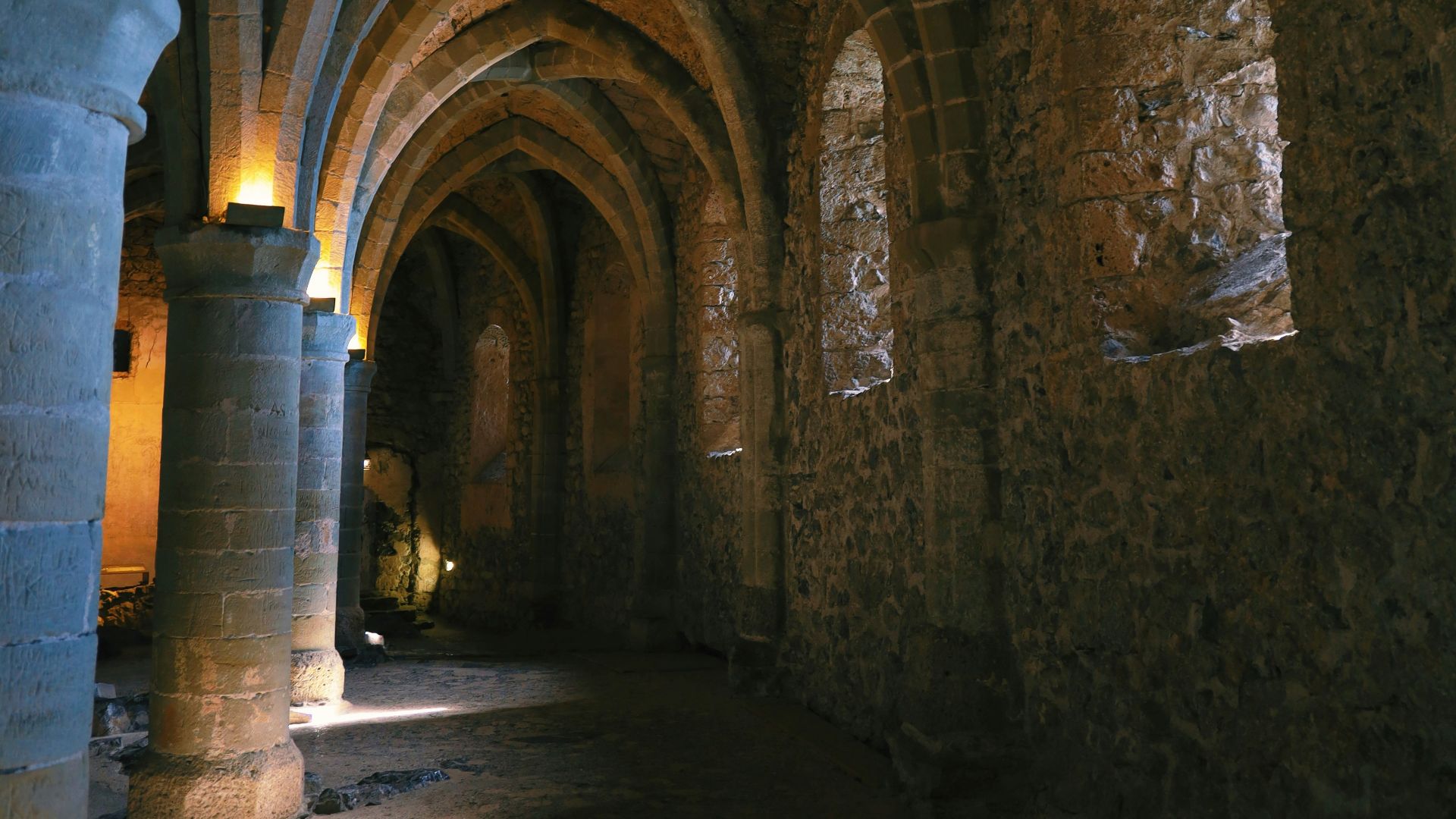 a large stone building with columns and lights