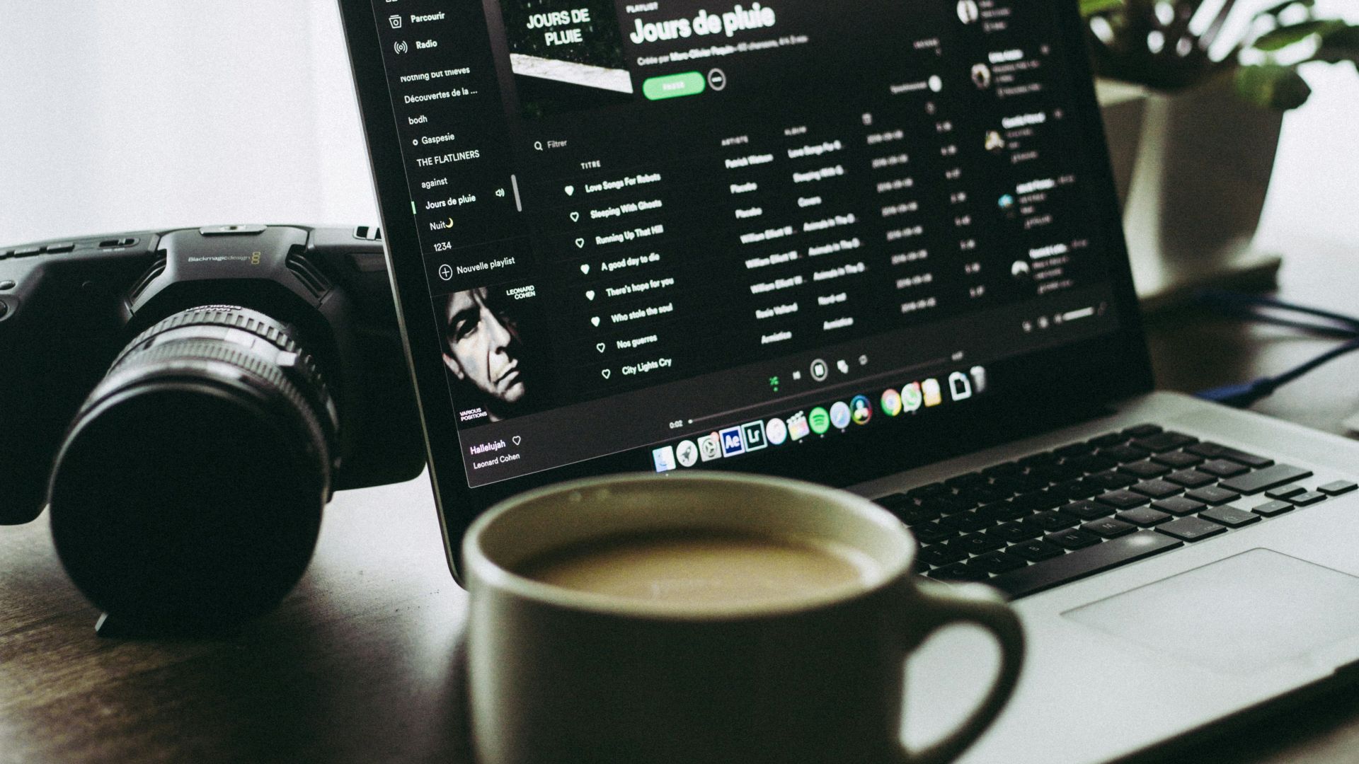 black and silver laptop computer beside white ceramic mug
