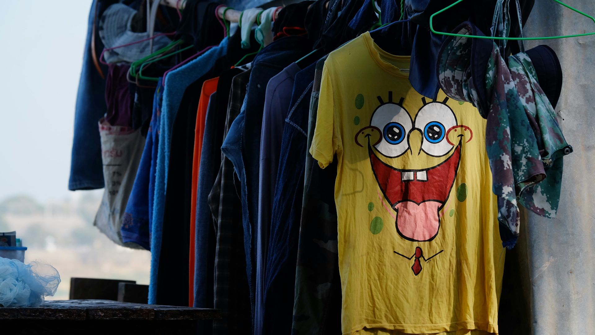 assorted shirt hanging on hanger near wall