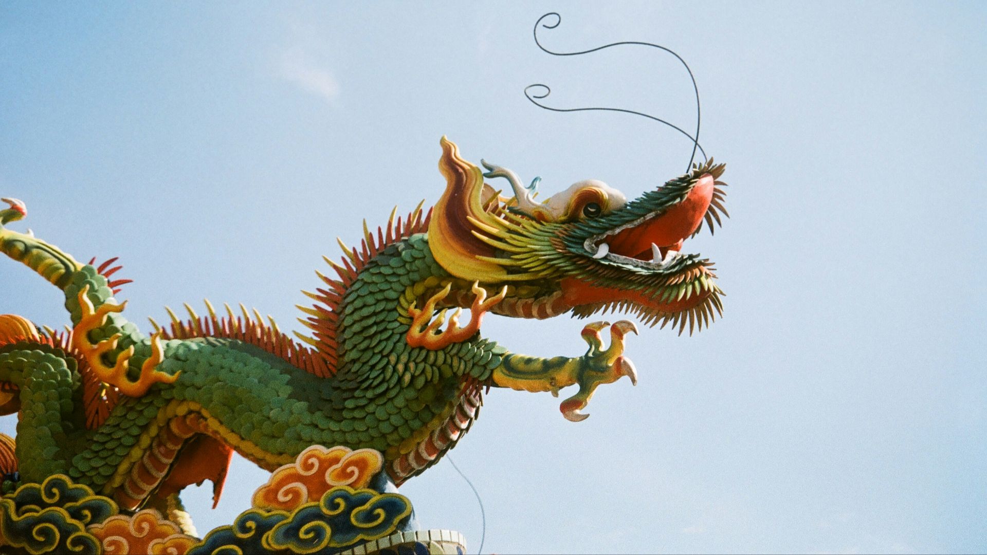 a dragon statue on top of a building