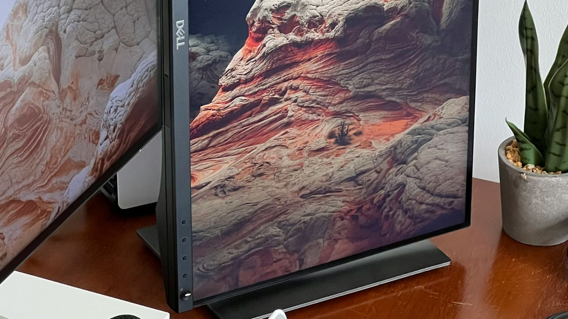 a desk with a computer and a camera on it