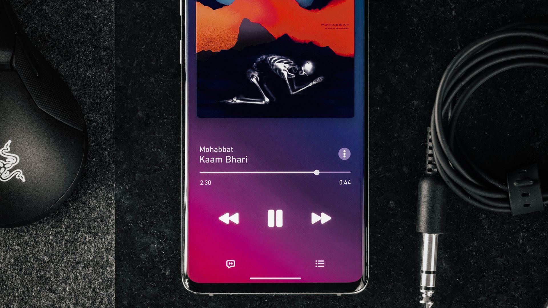 black android smartphone beside black corded computer mouse