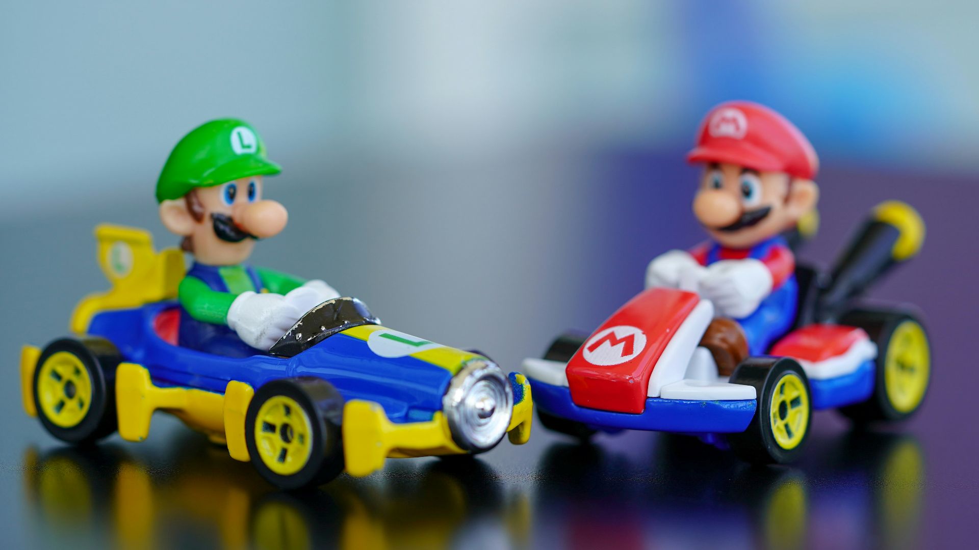 man in red helmet riding orange and blue f 1 car toy