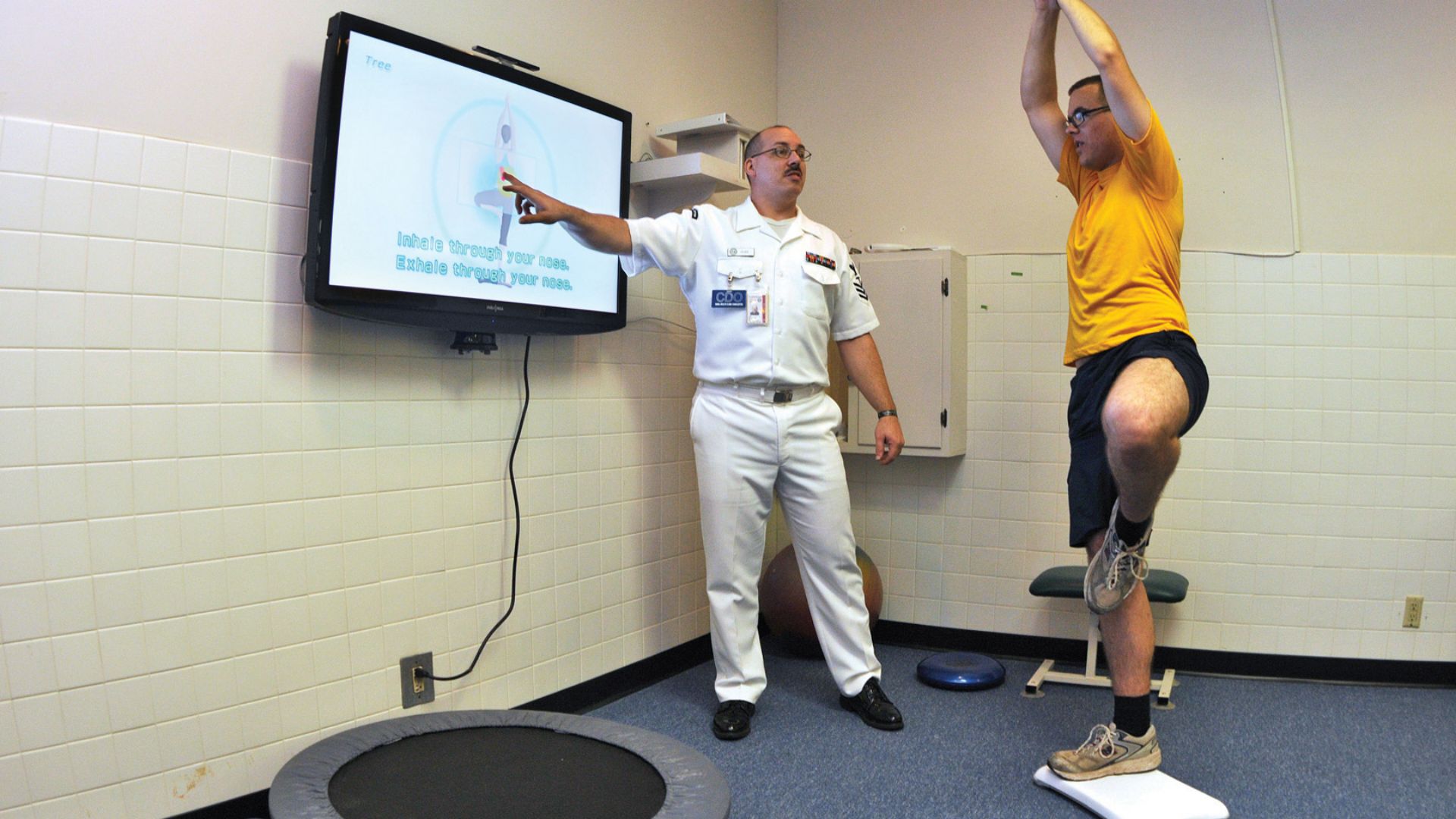 File:US Navy 090702-N-1783P-003 Hospital Corpsman 1st Class Guy Duke, left, and Electronics Technician 3rd Class Joshua Benedict demonstrate how the Physical therapy Department at Naval Health Clinic, Charleston use the Wii Fit's yoga.jpg