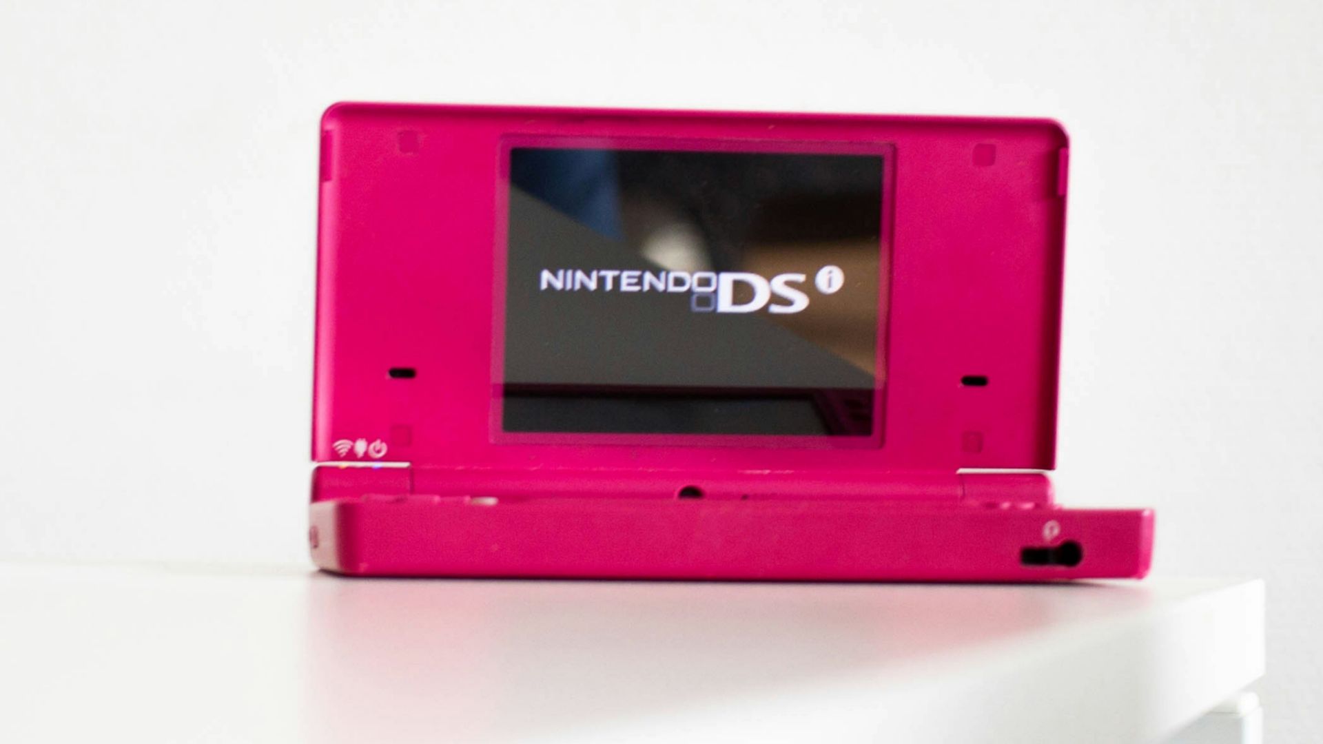 a pink video game sitting on top of a white table