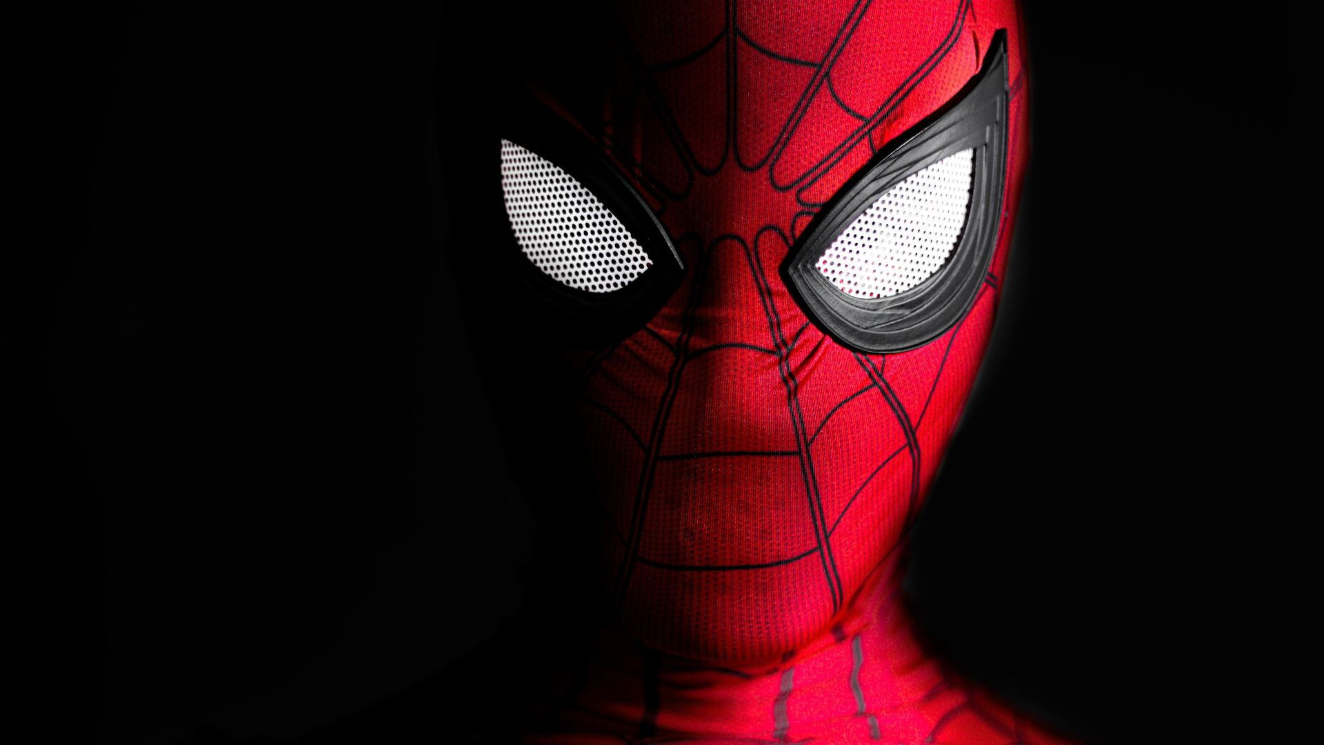 a close up of a spider man with glowing eyes