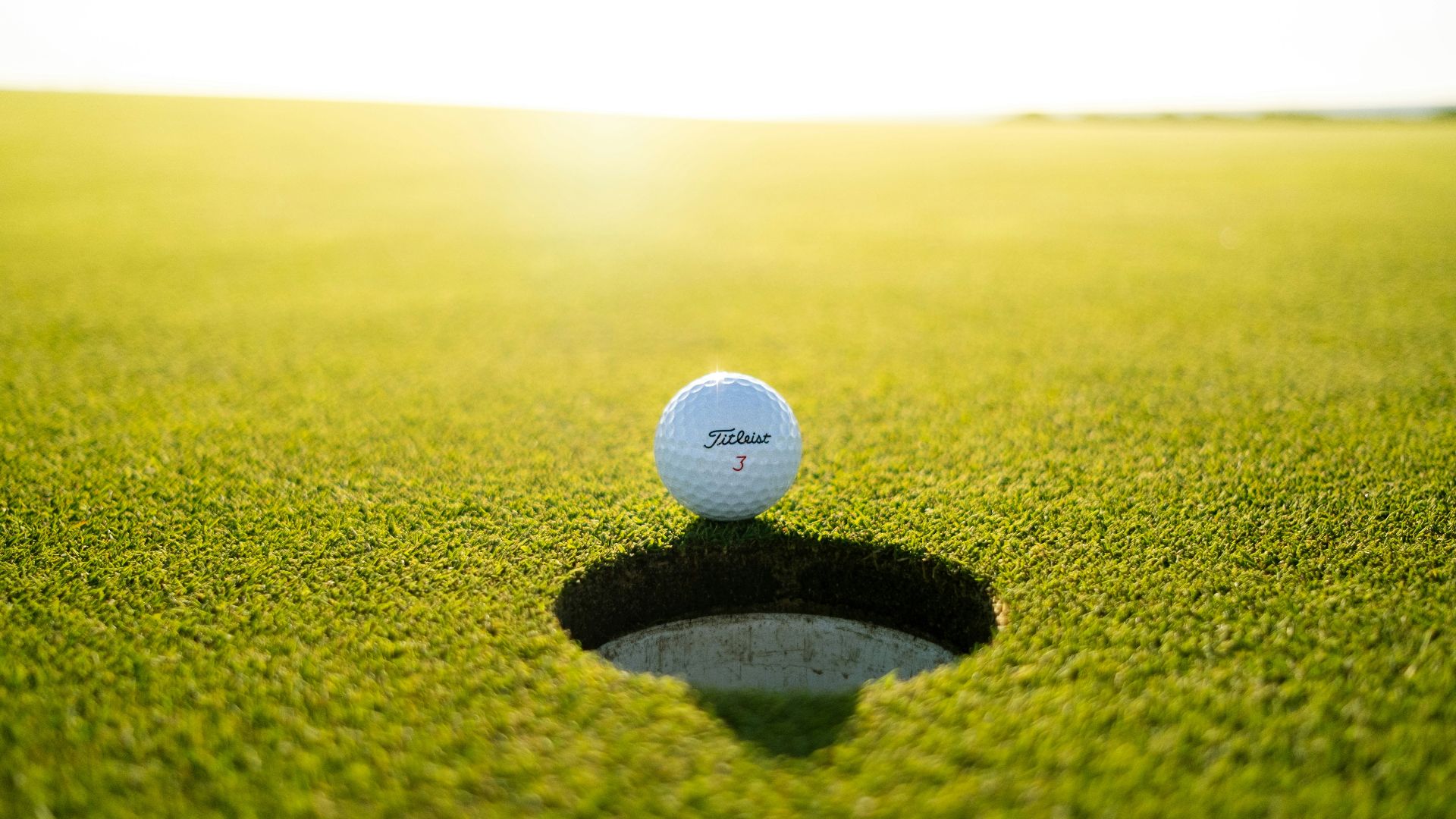 golf ball on green grass field during daytime