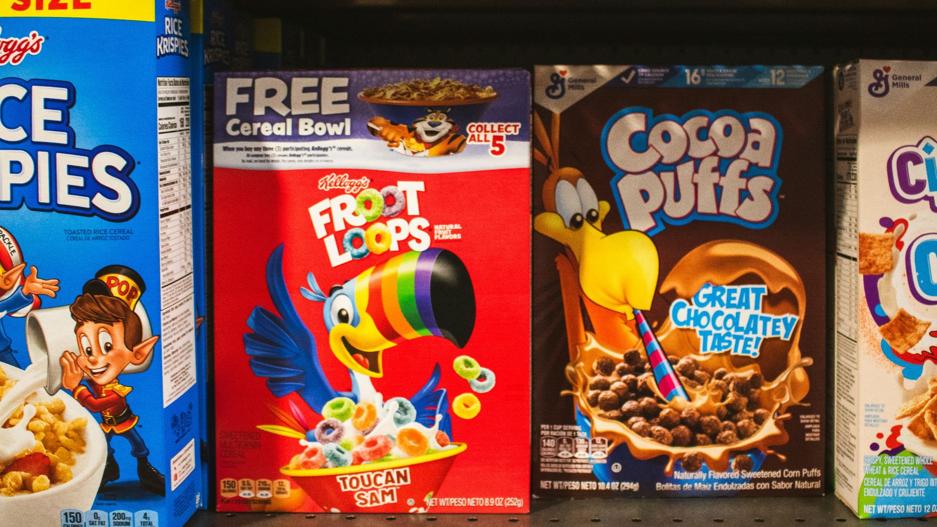 Cereal boxes displayed on a supermarket shelf.
