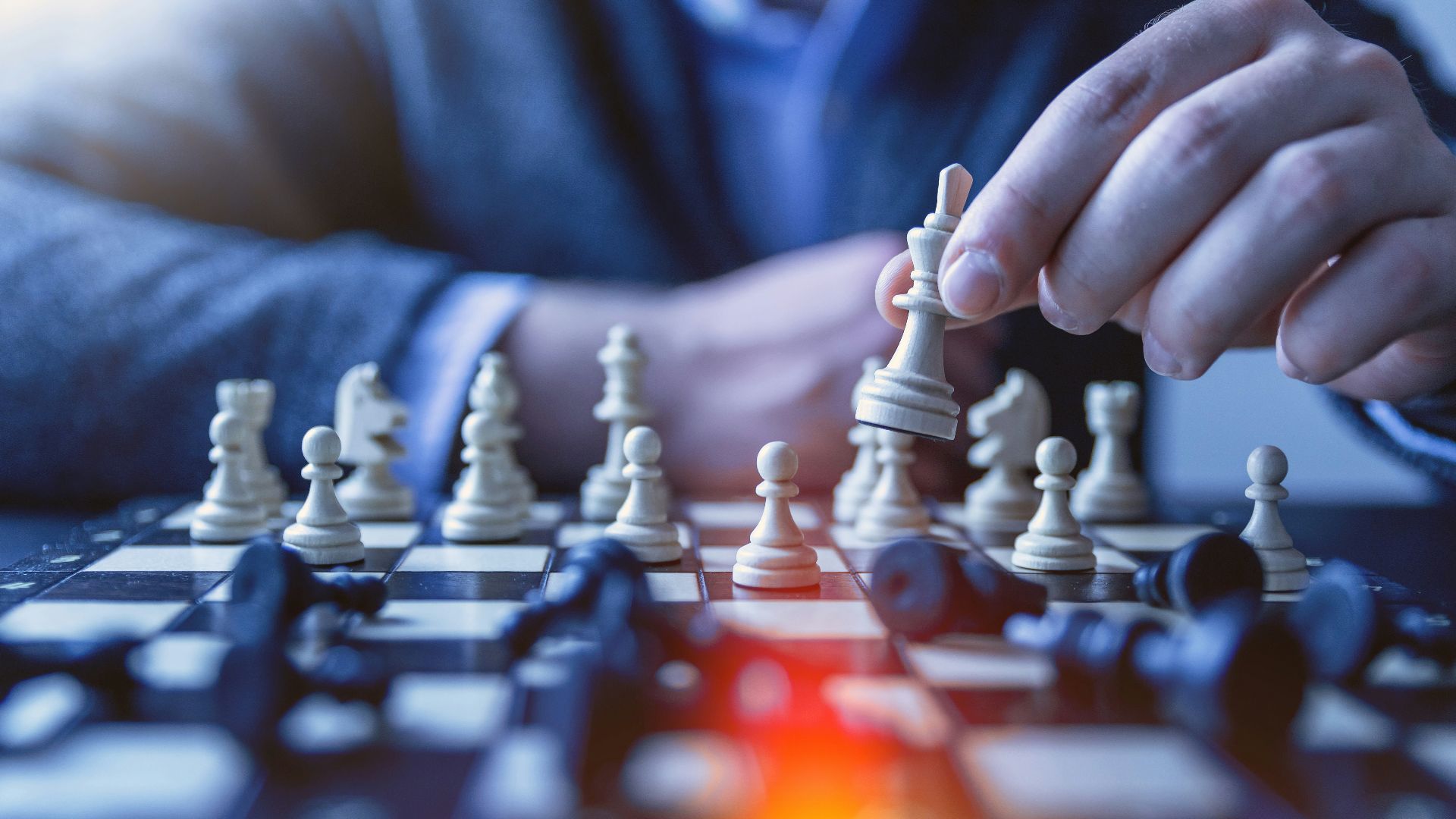 depth of field photography of man playing chess