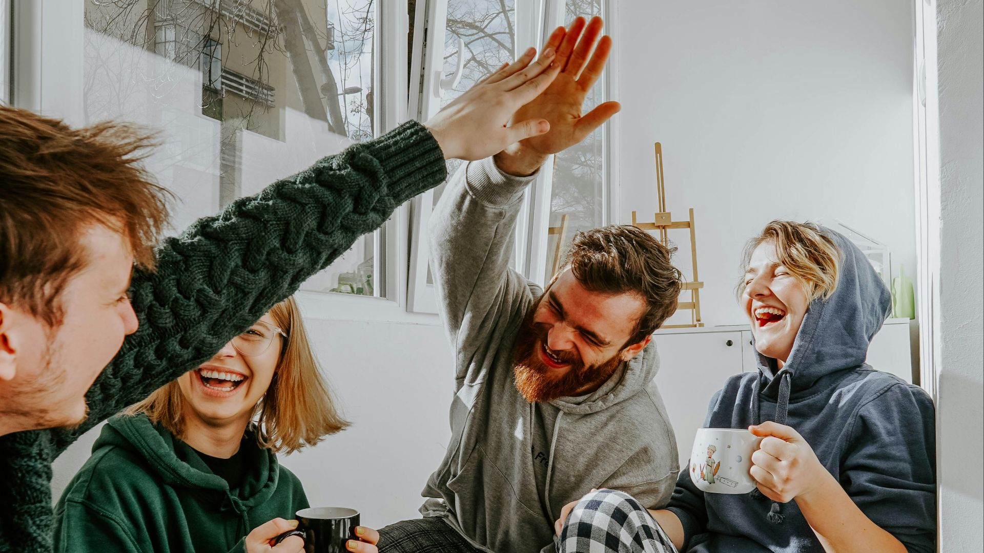 woman in black and white checkered long sleeve shirt sitting beside man in green crew neck