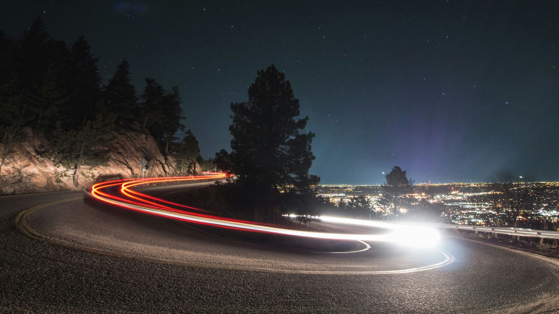 timelapse photography on curved road beside tree