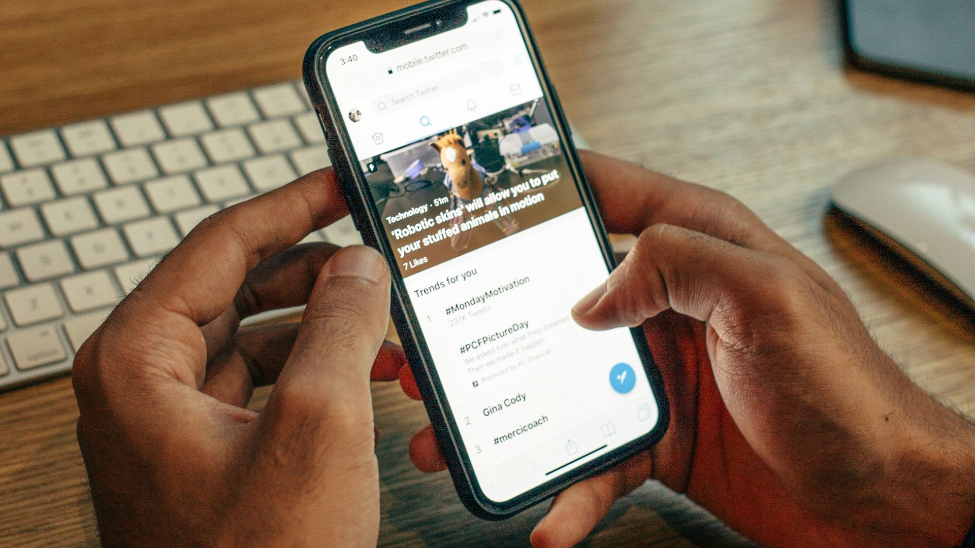person holding iPhone on table