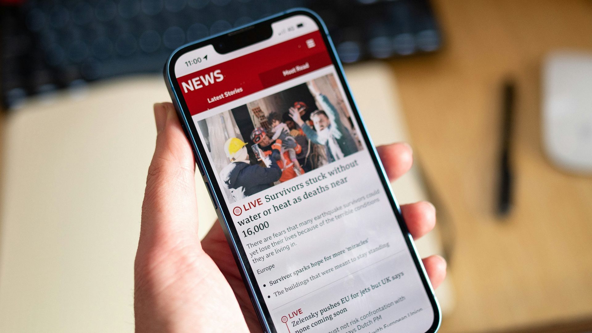 a person holding a cell phone in their hand