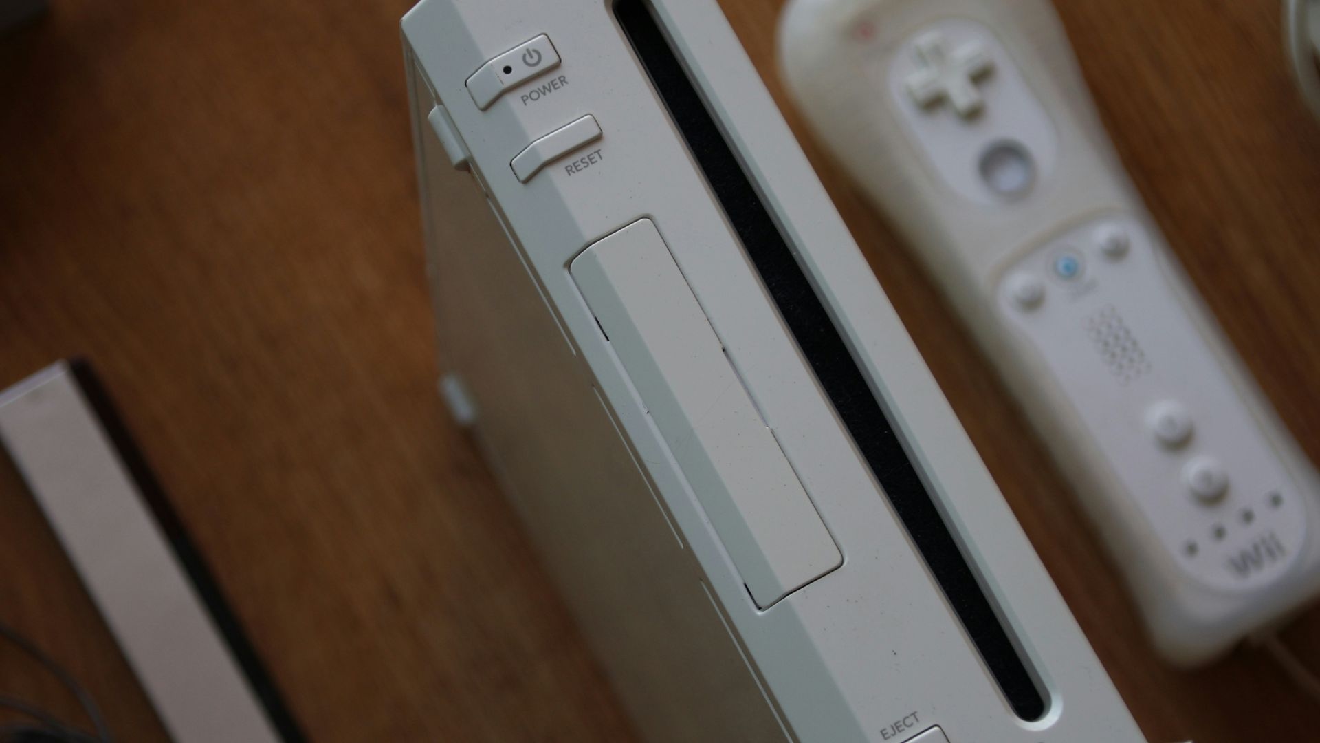 a nintendo wii game system sitting on top of a wooden table