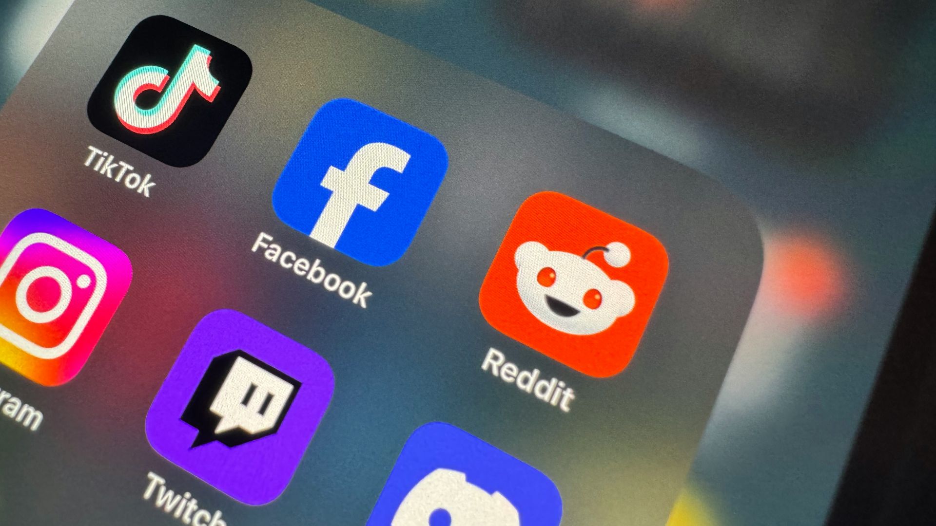 a close up of a cell phone with social icons on it