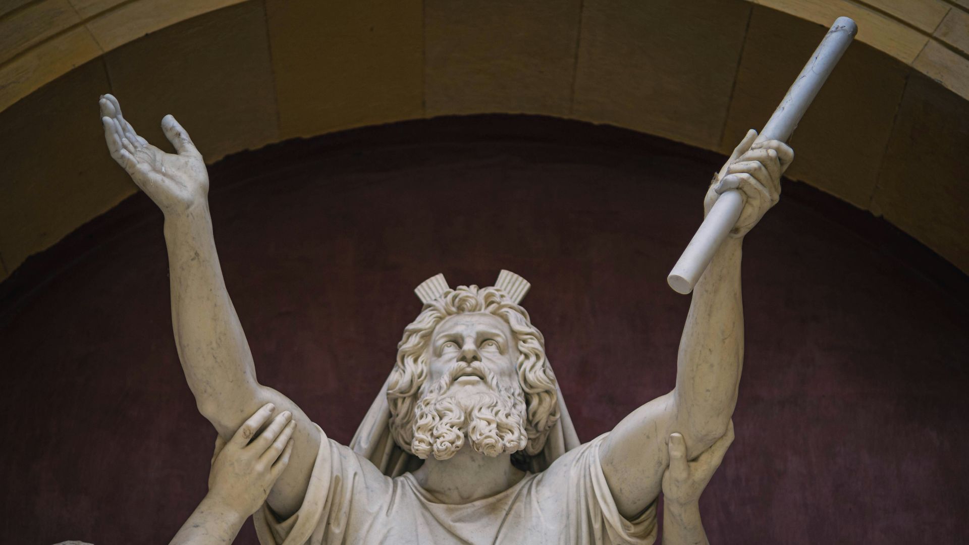 angel concrete statue on brown wooden table
