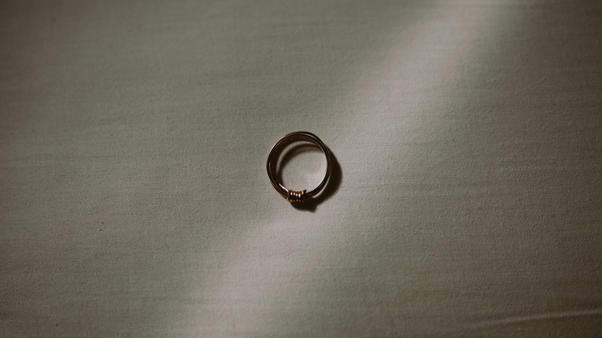 silver ring on gray textile