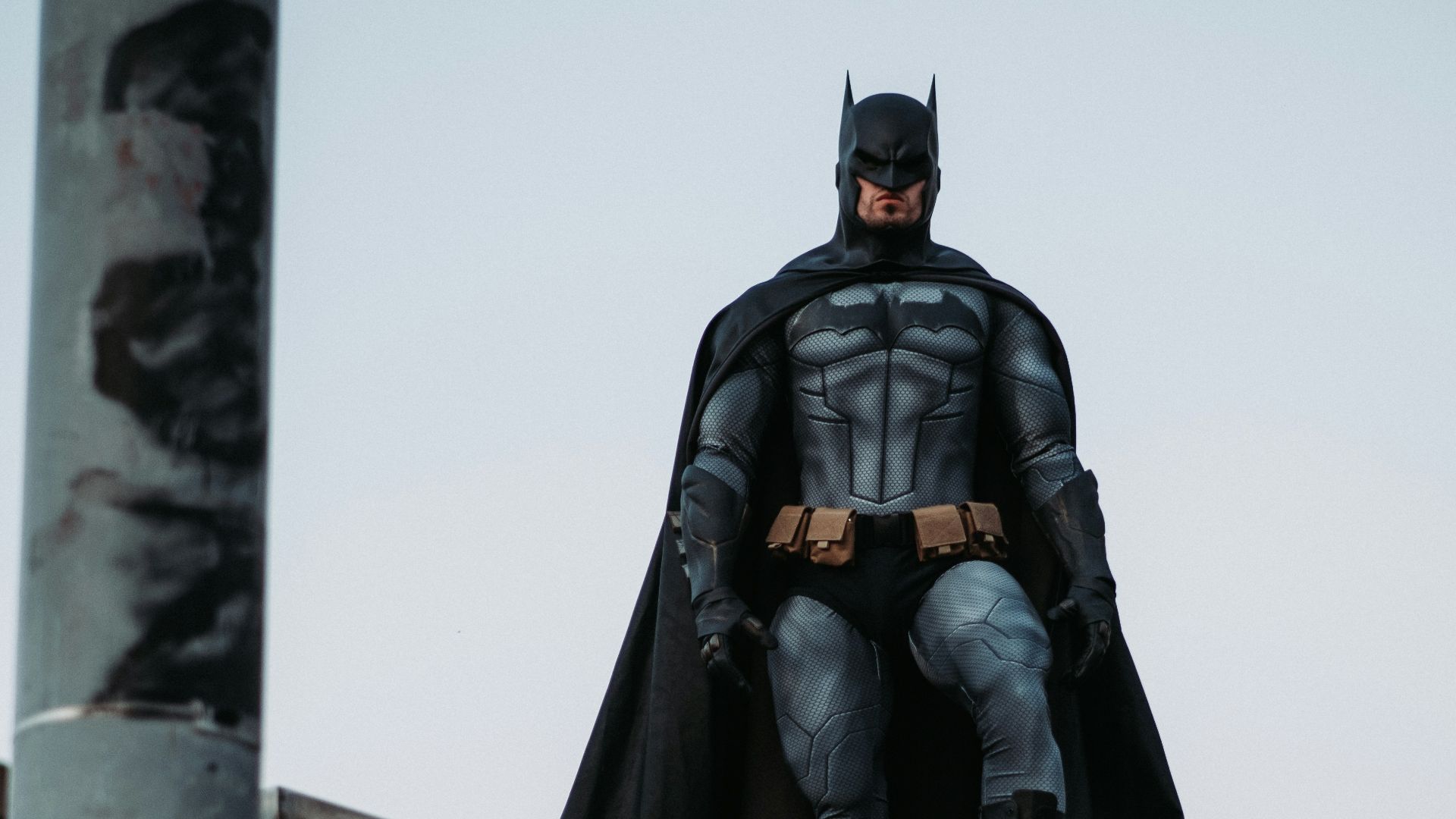 man in black jacket and pants standing on roof