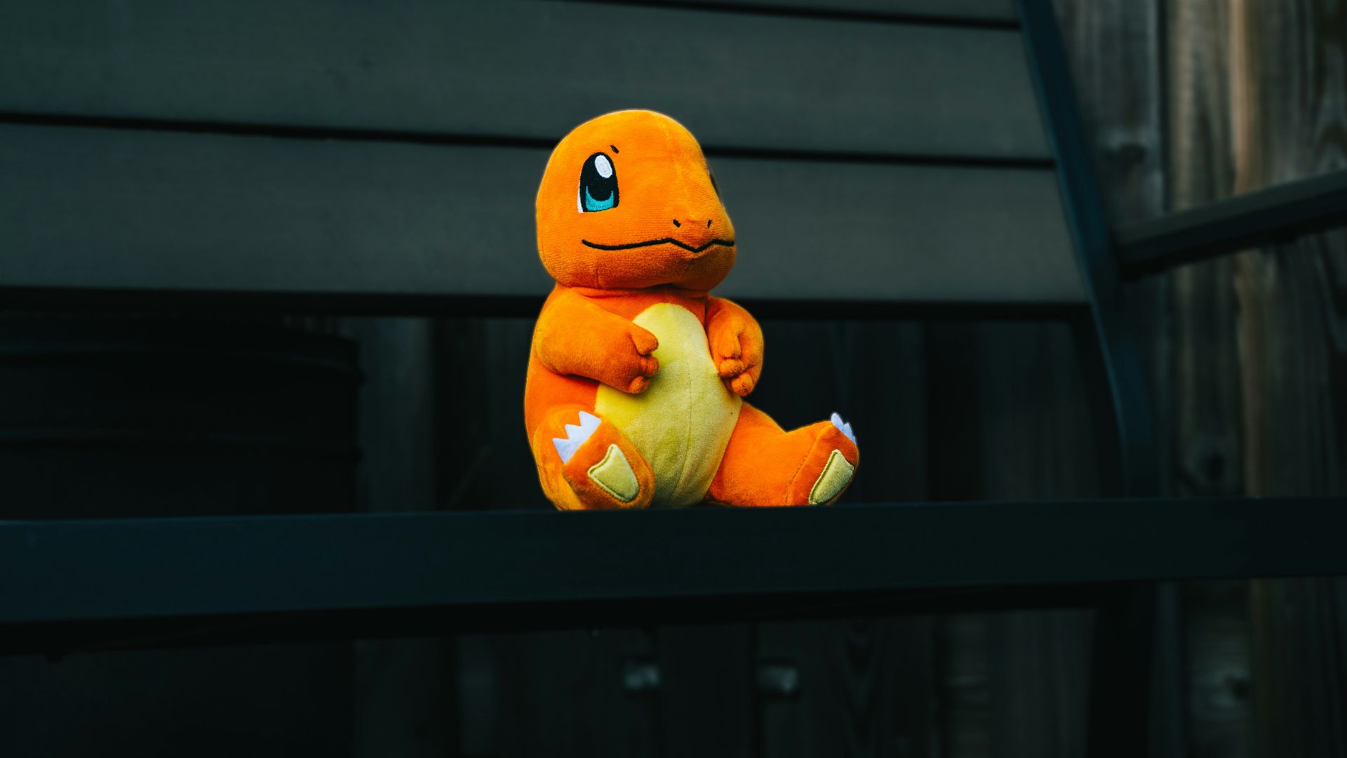 a stuffed toy sitting on top of a wooden bench